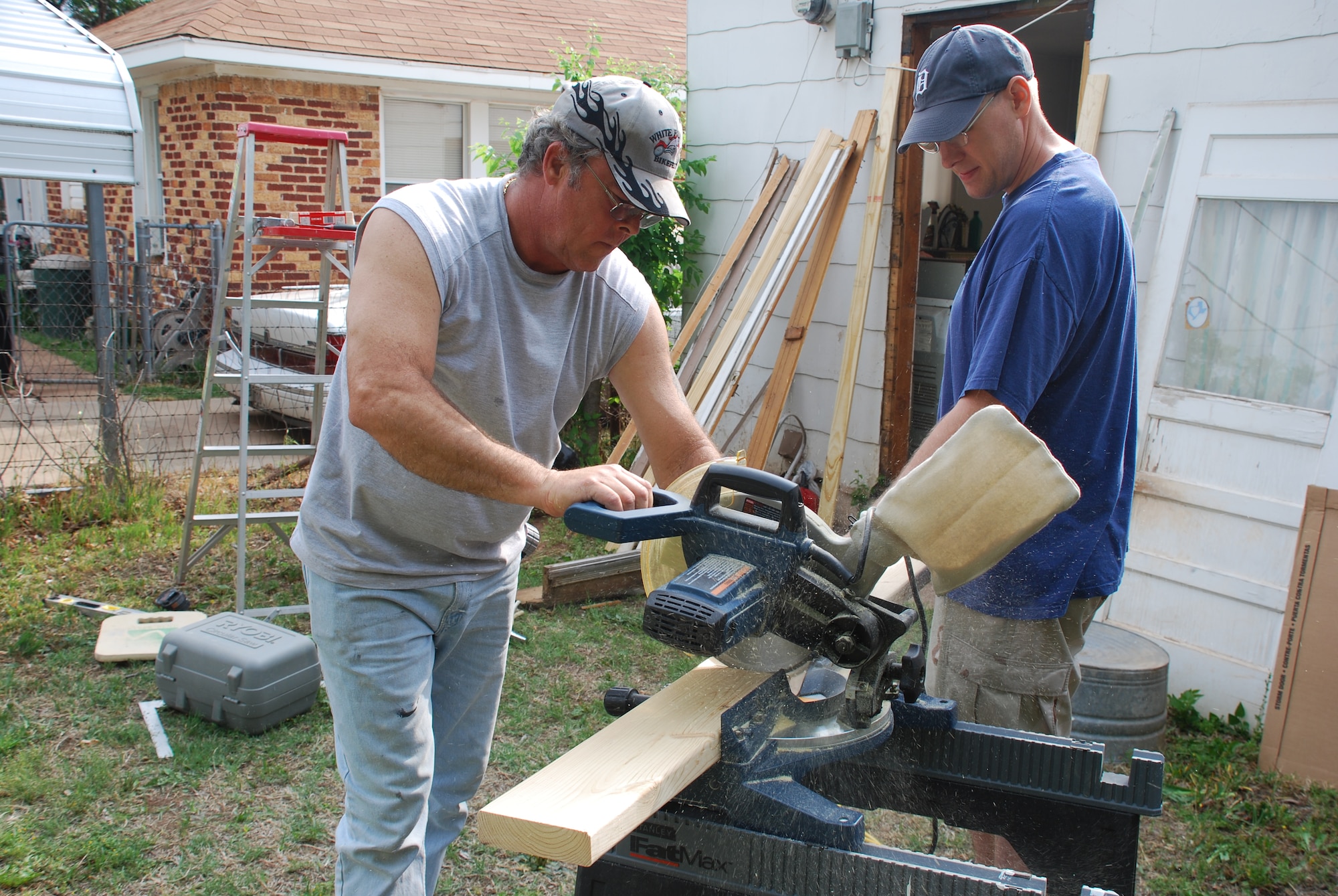 Staff Sgt. Scott Campbell, an Aircraft Electrical-Environmental instructor from the 364th Training Squadron, and Daniel Peterman, the instructor supervisor at the 364th TRS, cut boards to fix a door way at one of many houses that Sheppard volunteers worked on during Christmas In Action April 25. The objective of Christmas in action is to help the community in Wichita Falls, who need to make renovations to their houses but do not have the money or the ability to do it themselves. This year Sheppard took on 51 of the 60 houses that were renovated. (U.S. Air Force photo/Airman 1st Class Matthew Varga)
