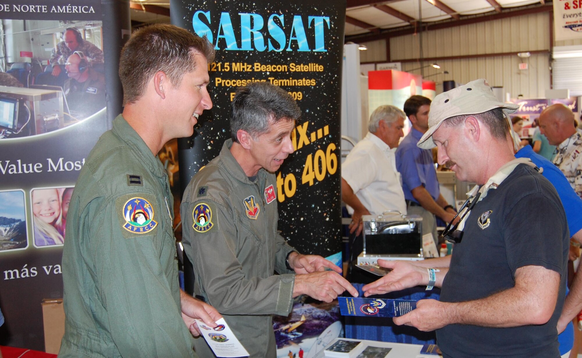 LtCol. Bill Clarke and Capt. Bob Nichols, members of the Air Force Rescue Coordiation Center, educate general aviation pilots and enthusiasts on search and rescue operations in the U.S. and the phase-out of 121.5/243.0 MHz ELT activation notification by the international search and rescue satellite system at this year's Sun 'n Fun fly-in in Lakeland, Fla.