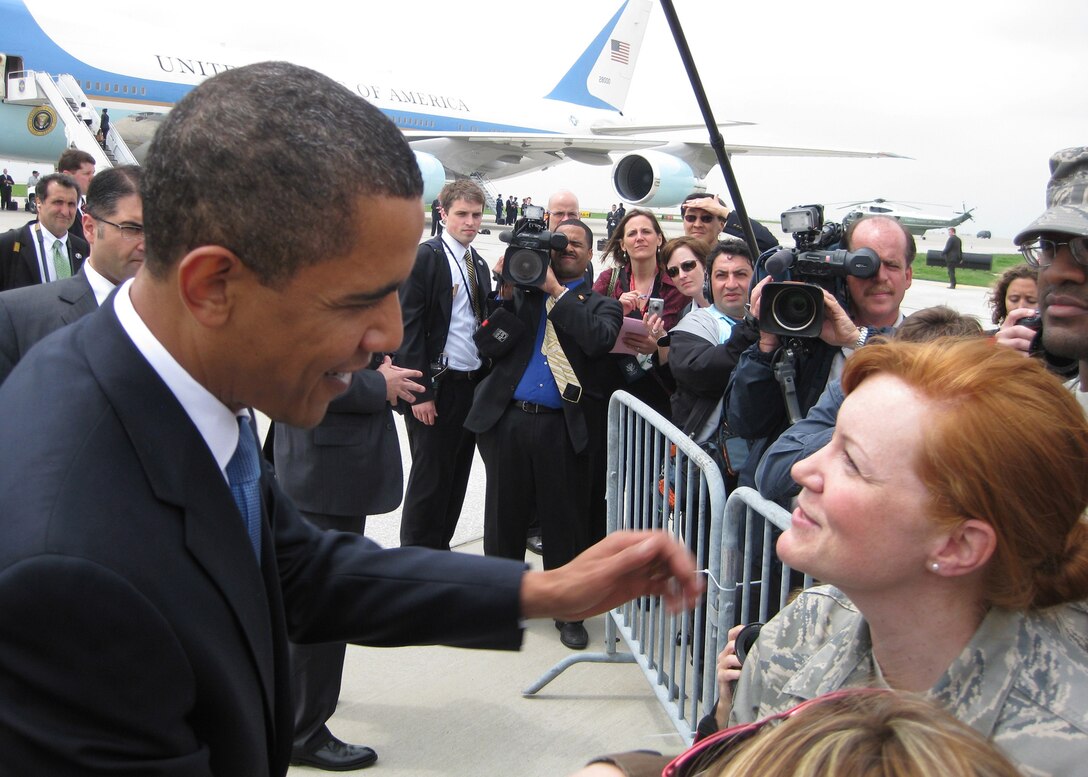 While the media looks on, President Barack Obama greets a member of the 131st Fighter Wing, Missouri Air National Guard, at Lambert-Saint Louis International Airport prior to his departure on Air Force One on April 29.  President Obama marked his 100th day in office with a Town Hall Meeting in Arnold, a surburb of Saint Louis, earlier that day. (U.S. Air Force Photo by Master Sergeant James McCullough)  (RELEASED)