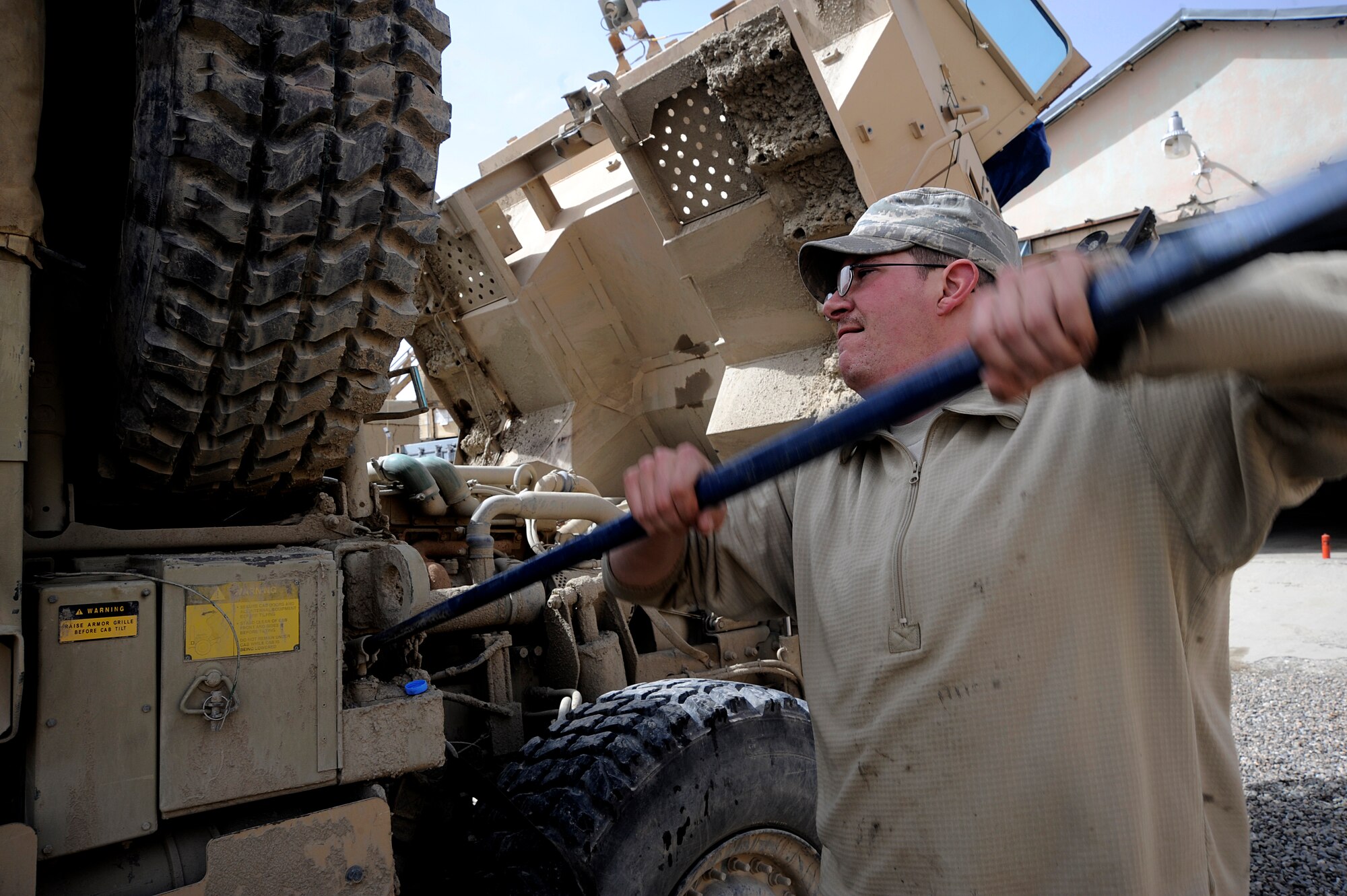 U.S. Air Force Staff Sgt. Robert Reich a vehicle maintainer assigned to the Provincial Reconstruction Team, Forward Operating Base Gardez, Afghanistan, lowers the spare tire for a Medium Tactical Vehicle, April 20, 2009. Staff Sgt. Reich is deployed from the 35th Logistics Readiness Squadron, Misawa Air Base, Japan. (U.S. Air Force photo by Staff Sgt. Shawn Weismiller)