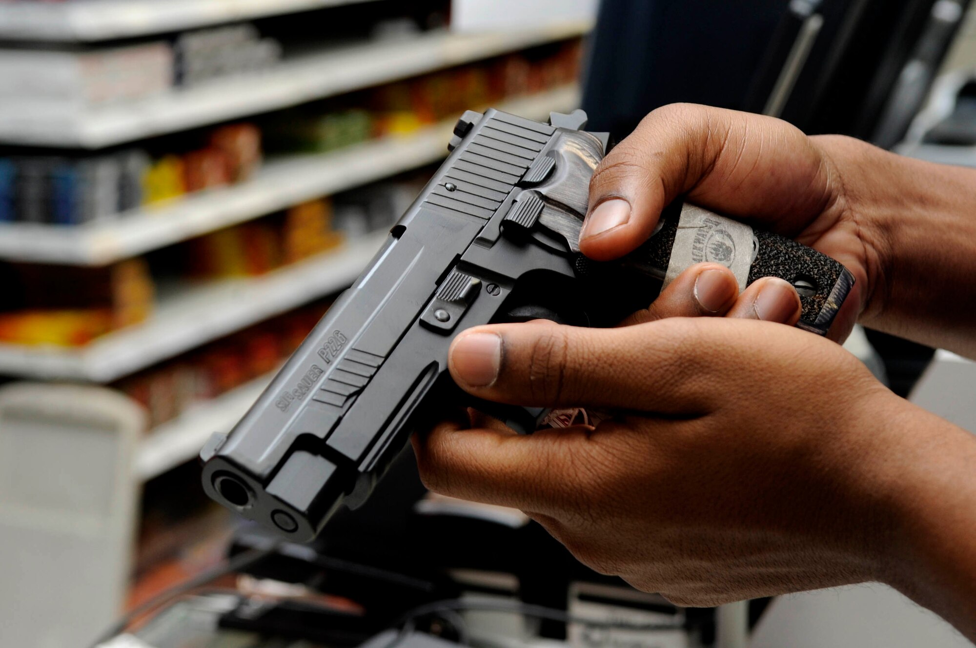 BARKSDALE AFB, La.-A patron at the Barksdale Base Exchange shops for a
new pistol.  The Gun Shop offers a wide variety of weapons including
pistols, rifles, shotguns and pellet guns. Barksdale's BX began selling in
November 2006 and has sold more than $100,000 in weapons, ammunition and
accessories since that date. (USAF photo by TSgt Laura K. Smith)
