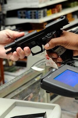 BARKSDALE AFB, La.-A patron at the Barksdale Base Exchange shops for a new pistol. The Gun Shop offers a wide variety of weapons including pistols, rifles, shotguns and pellet guns. Barksdale's BX began selling weapons in November 2006 and has sold more than $100,000 in weapons, ammunition and accessories since that date. (USAF photo/TSgt Laura K. Smith)