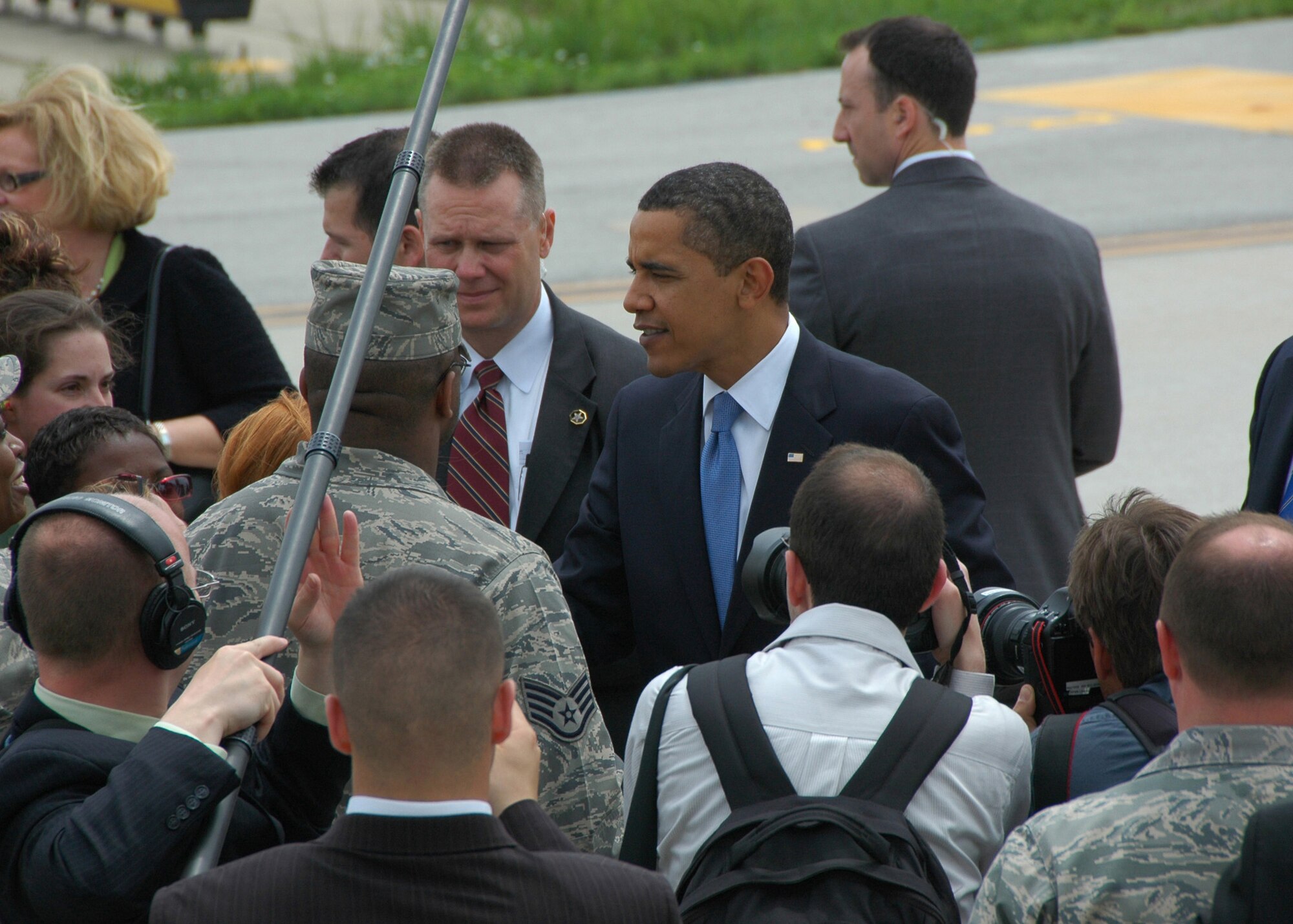 While the media looks on, President Barack Obama greets members of the 131st Fighter Wing, Missouri Air National Guard, at Lambert-Saint Louis International Airport prior to his departure on Air Force One April 29.  President Obama marked his 100th day in office with a Town Hall Meeting in Arnold, a surburb of Saint Louis, earlier that day. (U.S. Air Force Photo by Master Sergeant Mary-Dale Amison)  (RELEASED)