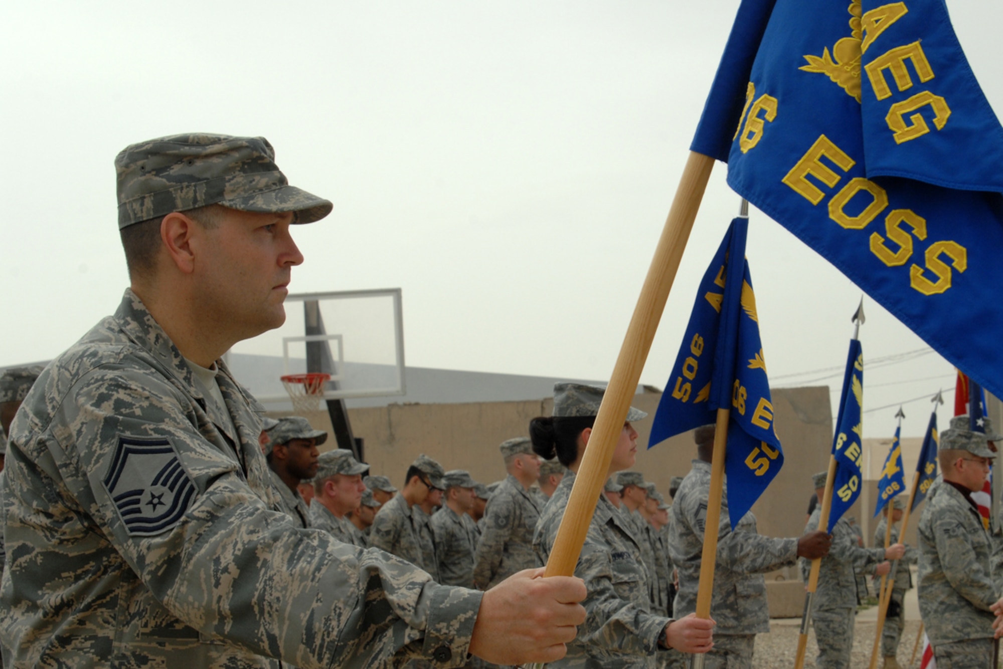 KIRKUK REGIONAL AIR BASE, Iraq – Senior Master Sgt. Jack Henry, 506th Expeditionary Operations Support Squadron first sergeant, displays the squadron guidon with other squadron first sergeants in flight formations during the 506th Air Expeditionary Group change-of-command ceremony here April 30. Col. Eric Overturf assumed command from Col. John Costa during the approximately 30-minute ceremony. Henry, a Sacramento, Calif., native, is deployed here from Offutt Air Force Base, Neb. (U.S. Air Force photo / Staff Sgt. Eunique Stevens)
