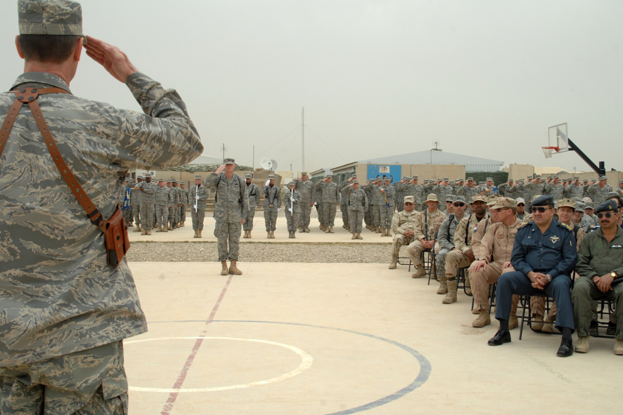 KIRKUK REGIONAL AIR BASE, Iraq – Col. Eric Overturf, 506th Air Expeditionary Group commander, receives his first salute as commander during the 506th AEG change-of-command ceremony here April 30. Colonel Overturf, a Greeley, Colo., native deployed here from Elmendorf Air Force Base, Alaska, assumed command from Col. John Costa during the approximately 30-minute ceremony. (U.S. Air Force photo / Staff Sgt. Eunique Stevens)