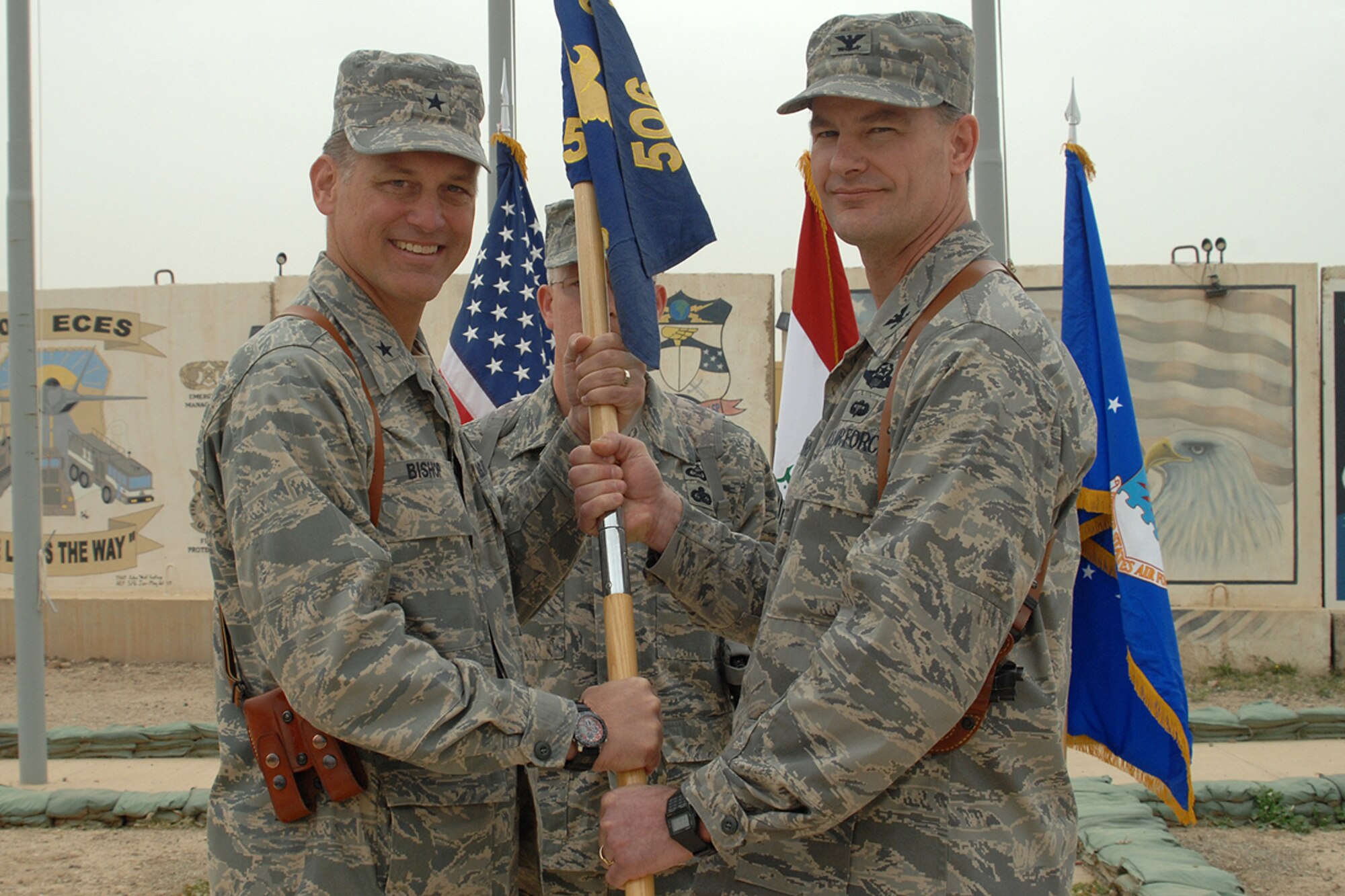KIRKUK REGIONAL AIR BASE, Iraq – Col. Eric Overturf, 506th Air Expeditionary Group commander, accepts the group guidon from Brig. Gen. Brian Bishop, 332nd Air Expeditionary Wing commander, during the 506th AEG change-of-command ceremony here April 30. Colonel Overturf, a Greeley, Colo., native deployed here from Elmendorf Air Force Base, Alaska, assumed command from Col. John Costa during the approximately 30-minute ceremony. (U.S. Air Force photo / Staff Sgt. Eunique Stevens)
