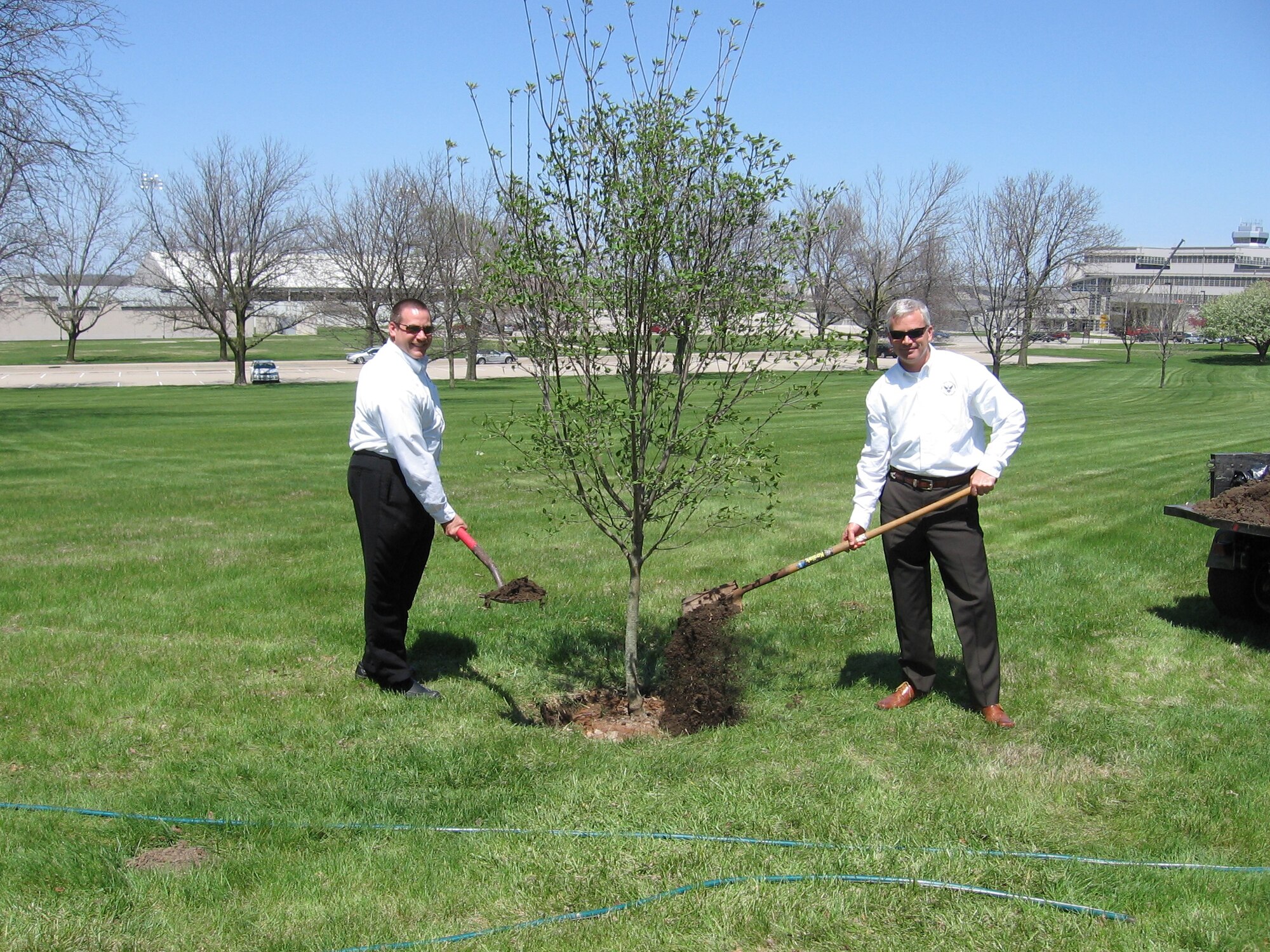 Dennis Mattson, 88th Air Base Wing Civil Engineer director, and Dave Perkins, 88th ABW CE deputy director, planted a 2-inch white dogwood April 24 in front of 88th ABW Headquarters,in commemoration of Arbor Day. 