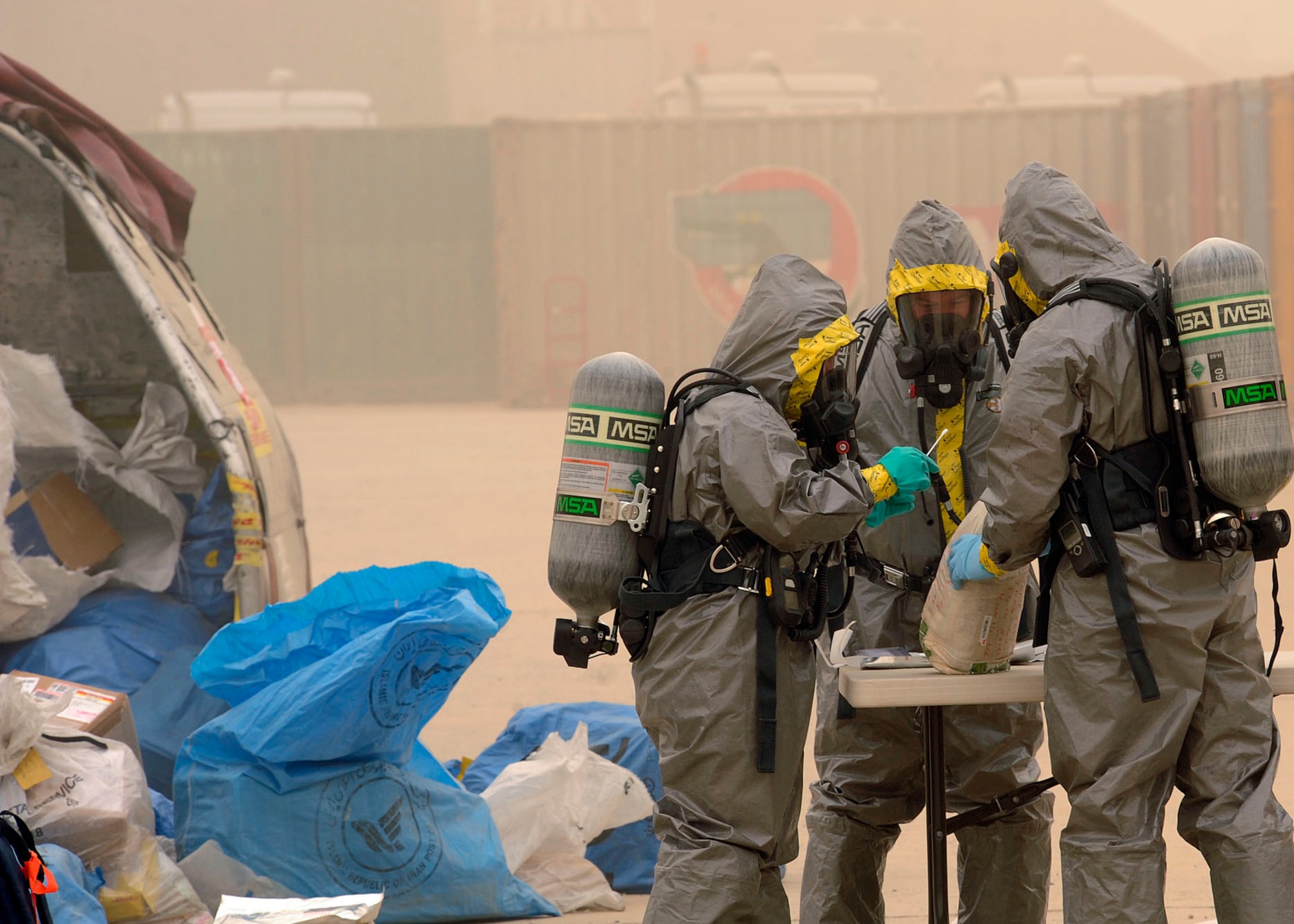 The 447th Expeditionary Civil Engineer Squadron emergency management flight conducts a biological test to ensure the random or selected packages are not contaminated Camp Stryker, Iraq April 24, 2009. All mail that comes into Baghdad that is improperly labeled, doesn’t have a return address or gets lost in the system has to be inspected before they can be processed and get it to the intended destination. The Iraqi government returns the mail to the Joint Military Mail Terminal on good faith but the military here has to take necessary precautions because the mail left the military postal system. When the JMMT gets the mail back from the Iraqi government it is ran through x-ray, inspected by military working dogs and then inspected by the 447th ECES emergency management flight for suspicious and/or hazardous materials which might have inadvertently come in contact with or intentionally added to the mail.  The Airmen, armed with chemical suits and hazardous material sensors make their way downrange in teams of three, where the mail is stored and run test on the packages for radiological, chemical and biological material. The inspection process is a joint effort between emergency management team, readiness, the fire department, and biological engineers. (U.S. Air Force photo by Senior Airman Jacqueline Romero)