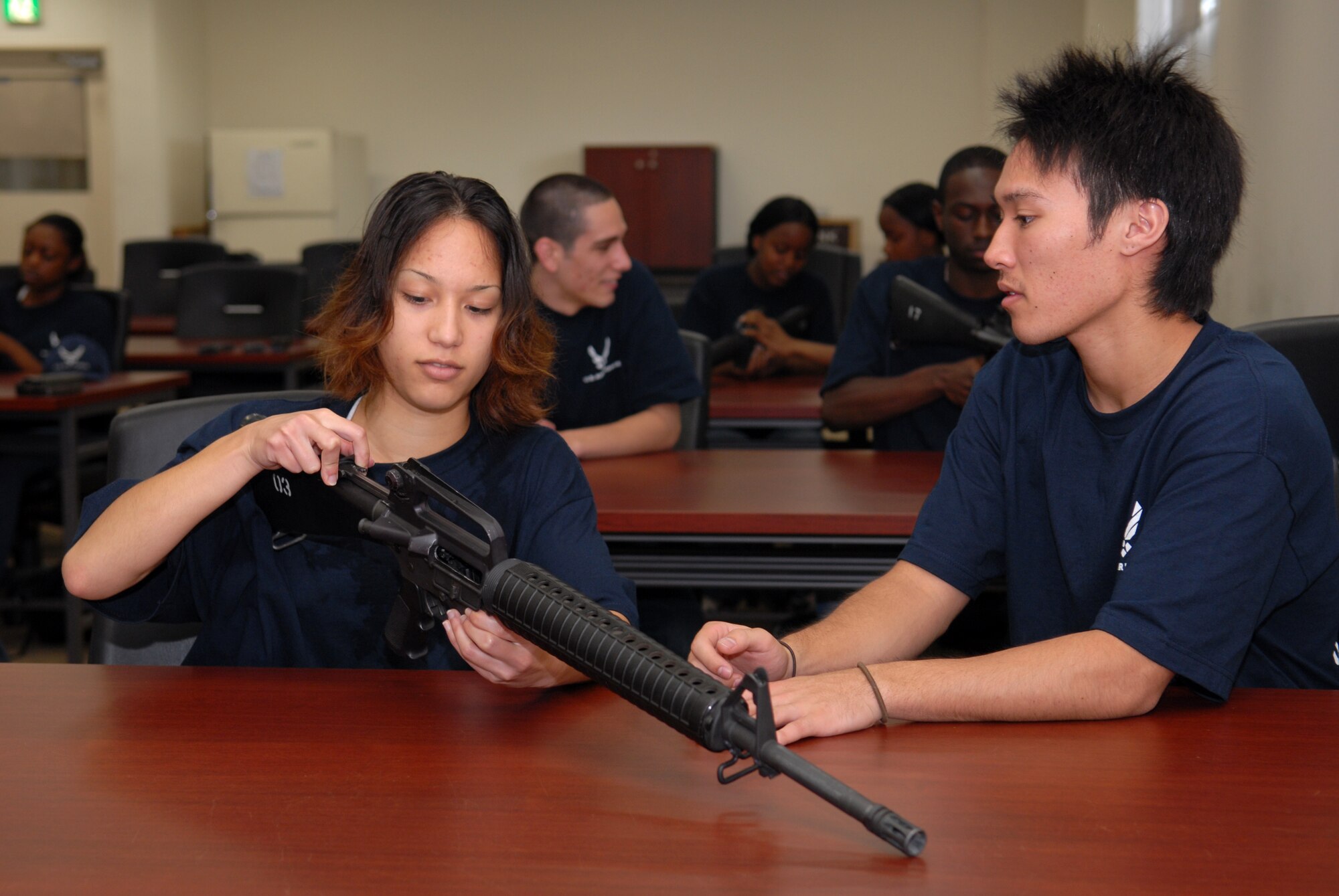 U.S. Air Force recruits Sarah Meyer  and Justin Cameron, both  in the Delayed Enlistment Program, receive M-16 familiarization training as part of the "Day at BMT" program April 25 at Kadena Air Base, Japan. The program was started to help prepare new recruits for Basic Military Training.
(U.S. Air Force photo/Staff Sgt. Angelique Perez)