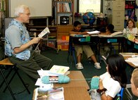 ANDERSEN AIR FORCE BASE, Guam -- Joseph Waggoner, Andersen Elementary School fourth-grade teacher, reads a book to his class April 30.  Andersen schools join with schools around the world to honor teachers during National Teacher Appreciation Week observed form May 3 to May 9. (U.S. Air Force photo by Airman Carissa Wolff)                               