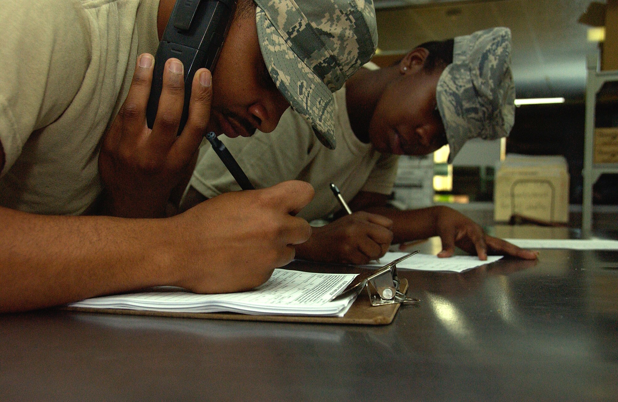 ANDERSEN AIR FORCE BASE, Guam -- Airman 1st Class Larry Coleman and Airman
1st Class Regina Rose, both 36th Force Support Squadron flight kitchen staff, take meal orders for pick up April 28. The Skyline Flight Kitchen recently moved to an office adjacent to the 734th Air Mobility Squadron passenger terminal. (U.S. Air Force photo by Airman Carissa Wolff)                          