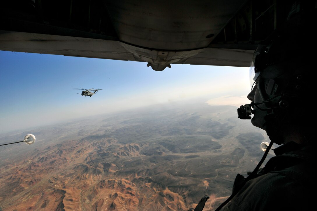A U.S. Marine CH-53E Super Stallion helicopter approaches an Air Force C-130P aircraft during a helicopter air refueling mission over Grand Bara, Djibouti, April 23, 2009. The helicopter crew is assigned to the Marine Heavy Helicopter Squadron Four Six One, and the aircraft crew is assigned to the 81st Rescue Squadron. The helicopter received 13,800 pounds of fuel during the 45-minute mission. The exercise consisted of transporting pararescuemen to a water jump, aerial refueling of a CH-53E helicopter, an assault landing on an unimproved runway, and transloading a simulated survivor from the CH-53E. 