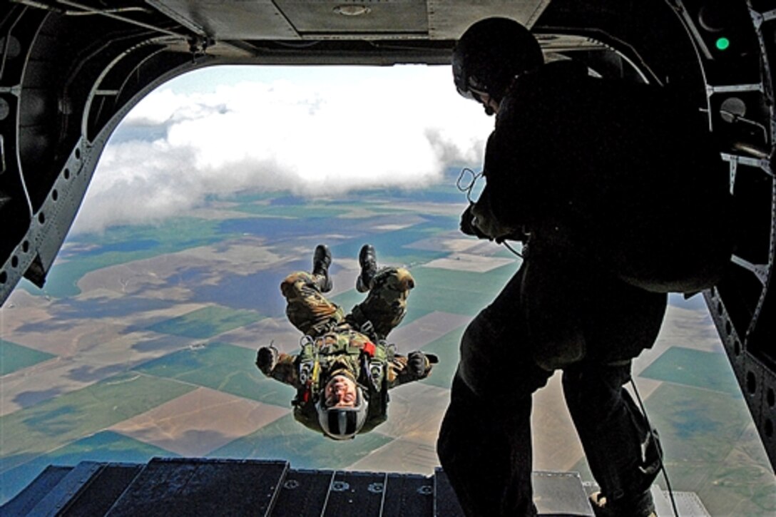 U.S. Air Force Tech. Sgt. Derrick Brooks back flips from an Oregon Army National Guard CH-47 Chinook helicopter at 7,200 feet during a jump demonstration in Pendleton, Ore., April 23. 2009. Brooks is a pararescue jumper assigned to the 304th Rescue Squadron, Air Force Reserve.