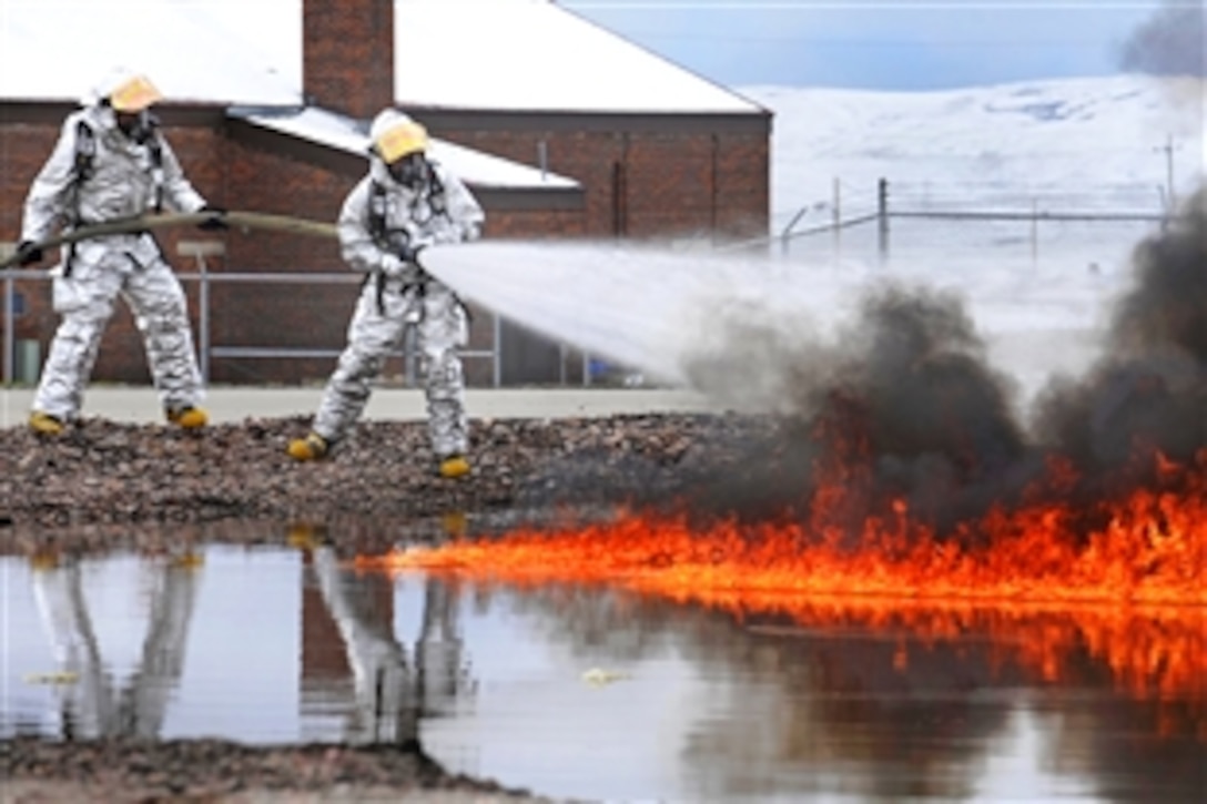 Firefighters from Rochester International Airport extinguish a fire during a training exercise on Ellsworth Air Force Base, S.D., April 27, 2009. The Rochester International Airport firefighters are being trained by U.S. Air Force personnel assigned to the 28th Civil Engineer Squadron.