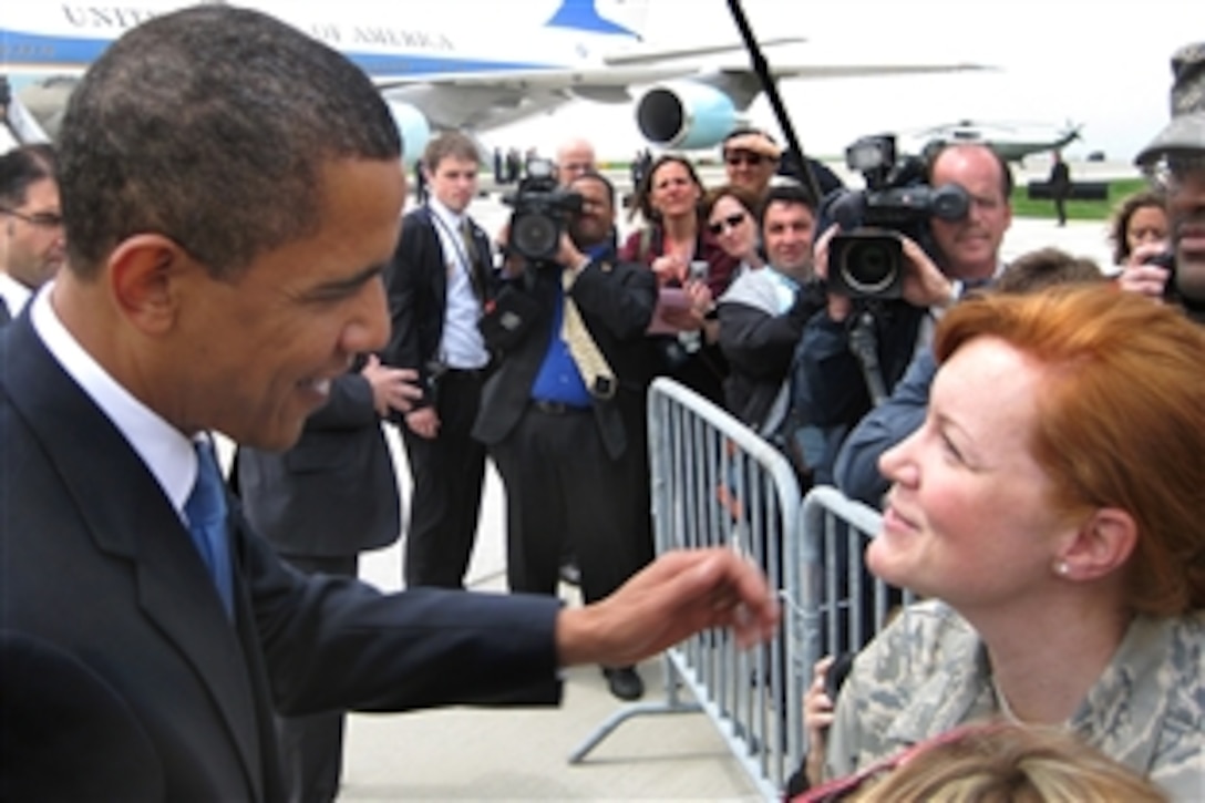 President Barack Obama greets a member of the 131st Fighter Wing, Missouri Air National Guard, before departing on Air Force One from Lambert-St. Louis International Airport in St. Louis, Mo., April 29, 2009. Obama marked his 100th day in office with a town hall meeting in Arnold, Mo.