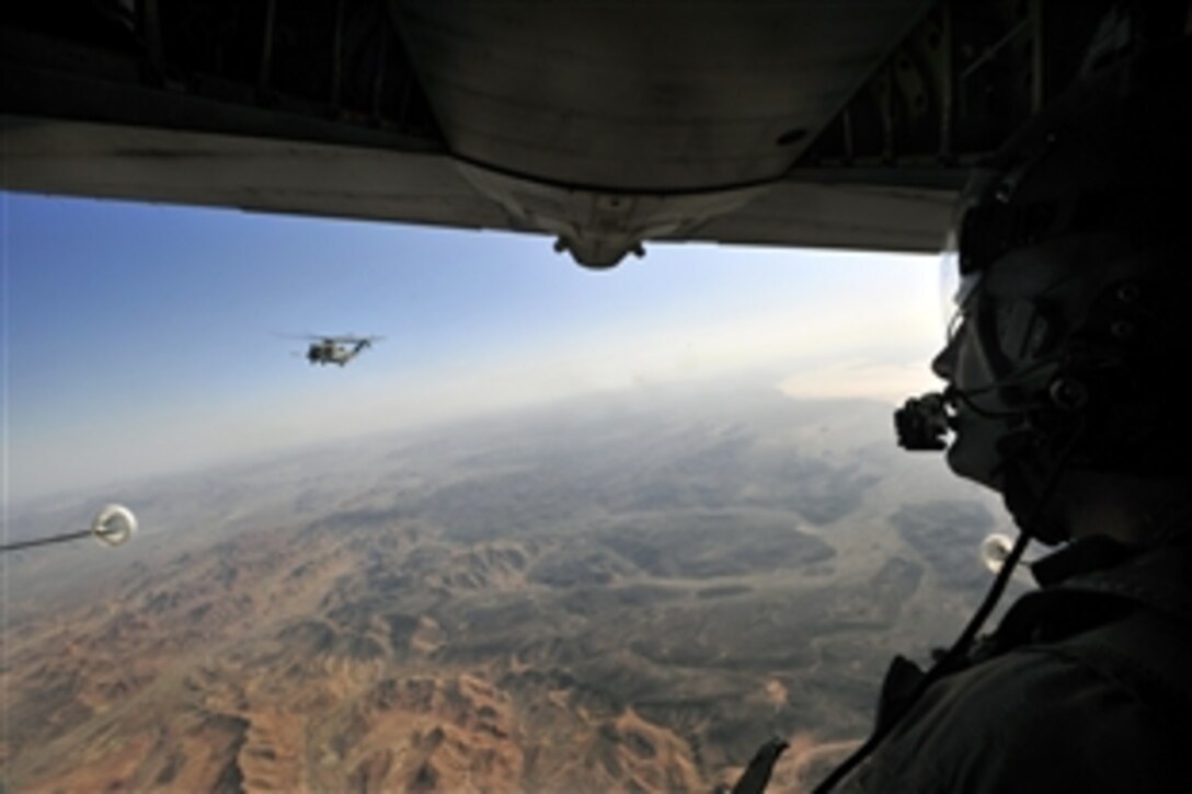 A U.S. Marine CH-53E Super Stallion helicopter approaches an Air Force C-130P aircraft during a helicopter air refueling mission over Grand Bara, Djibouti, April 23, 2009. The helicopter crew is assigned to the Marine Heavy Helicopter Squadron Four Six One, and the aircraft crew is assigned to the 81st Rescue Squadron. The helicopter received 13,800 pounds of fuel during the 45-minute mission.