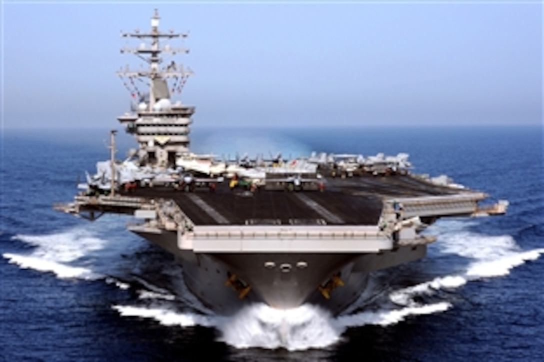 The aircraft carrier USS Dwight D. Eisenhower displays signal flags as it operates in the Arabian Sea, April 26, 2009. The USS Eisenhower Carrier Strike Group is underway on a scheduled deployment supporting Operation Enduring Freedom and the rotation of forward-deployed forces to support maritime security operations.