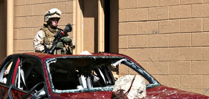 Marines with the search and extraction platoon at Chemical Biological Incident Response Force (CBIRF), II Marine Expeditionary Force prepare to enter a building to rescue simulated casualties, here, April 30. The unit hosted a civic leader tour to pass on information on how CBIRF integrates into the Incident Command System and works with other emergency responders.