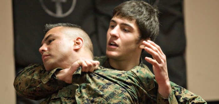 Civic leaders on a tour watch as Sgt. Christopher Lett, extractor, company A, Chemical Biological Incident Response Force (CBIRF), II Marine Expeditionary Force, performs a personal protective equipment emergency action, here, April 30. CBIRF hosted the civic leader tour to show how Marines operate in a contaminated area.