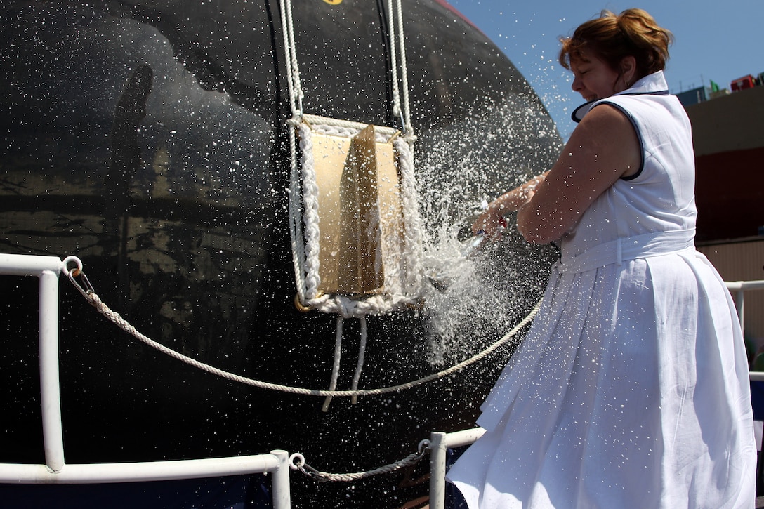 Deb Dunham christens the Arleigh Burke-class guided-missile destroyer Jason Dunham (DDG 109) at General Dynamics Bath Iron Works in Bath, Maine. The ship is named for her son, U.S. Marine Cpl. Jason Dunham, who was posthumously awarded the Medal of Honor for his actions in Operation Iraqi Freedom.