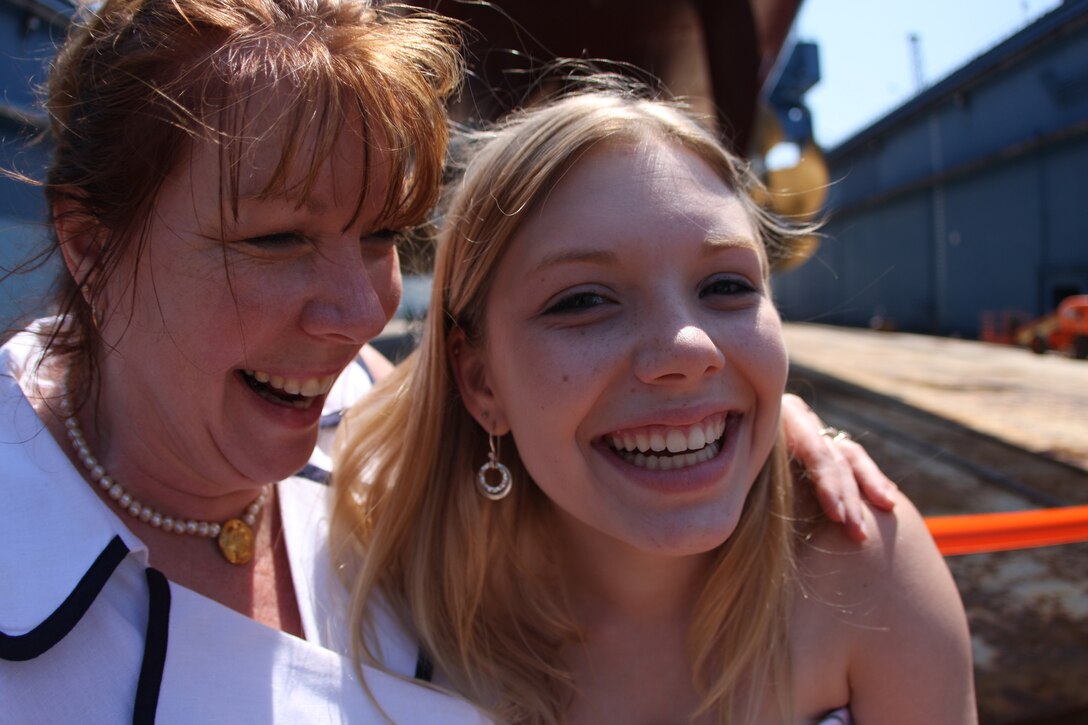 Deb and Katie Dunham, mother and sister of Medal of Honor recipient Cpl. Jason Dunham, share a joyous moment in front of the Navy destroyer USS Jason Dunham after its christening ceremony Saturday at Bath Iron Works in Bath, Maine.