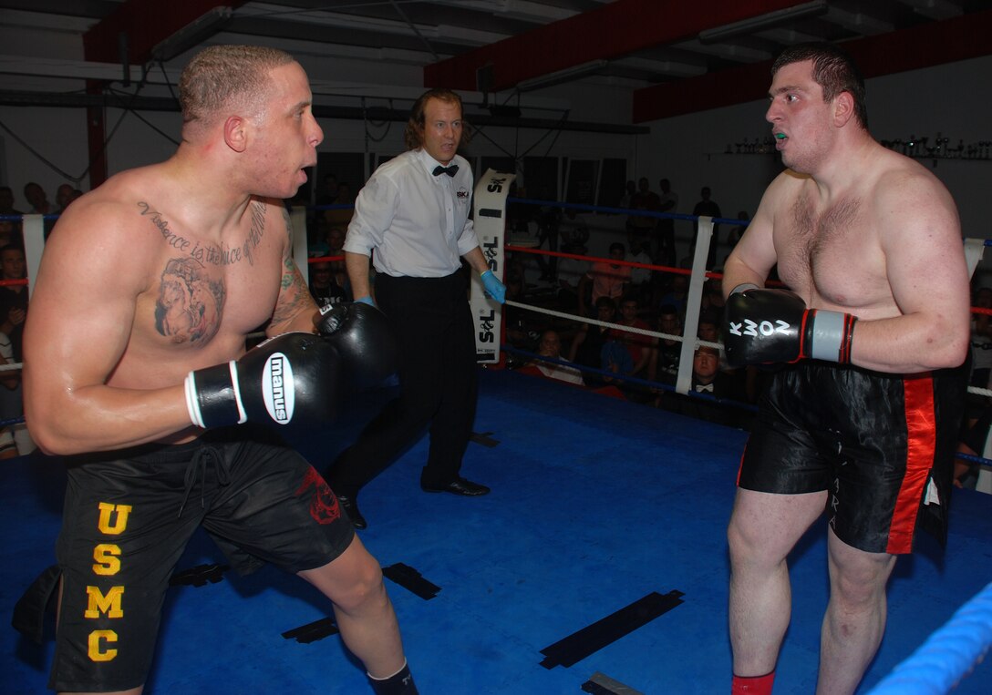 Sgt. Micah Terry (left) stares down his opponent, Vseyin Usta, at the start of the third round in his debut professional kickboxing match. Terry won the match by unanimous decision despite being outweighed by more than 70 pounds.