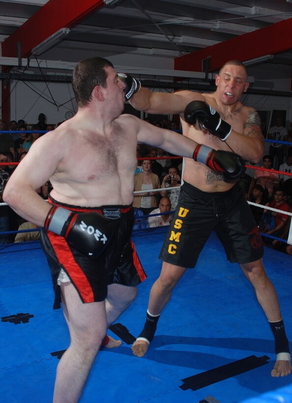 Sgt. Micah Terry (right), a guard force Marine with Marine Forces Europe, unleashes one of many heavy-handed blows to the face of his opponent, Vseyin Usta, during his debut professional kickboxing match. Terry improved his career record to 4-0 after winning the match by unanimous decision.