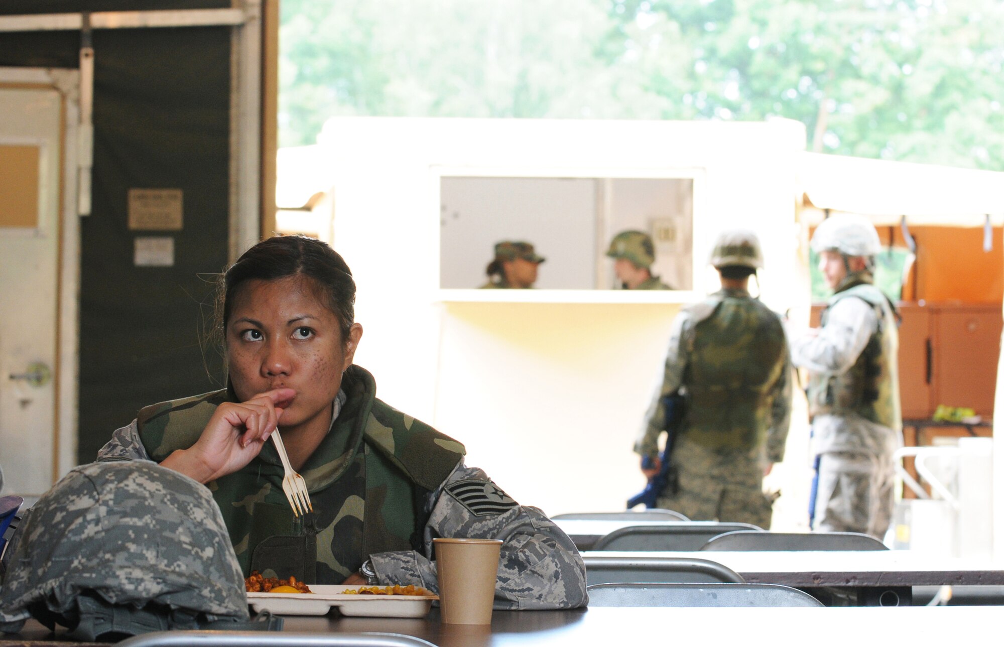 TSgt Jane Cummings, 31st Civil Engineer Squadron, Aviano Air Base, Italy, enjoys a hot lunch while participating in a week long contingency exercise Silver Flag on Ramstein Air Base, Germany, August 1, 2009. The Silver Flag exercise gives participants the basic contingency skills to set up a bed down operation anywhere in the world.(U.S. Air Force photo by: Tech. Sgt. Sean Mateo White)