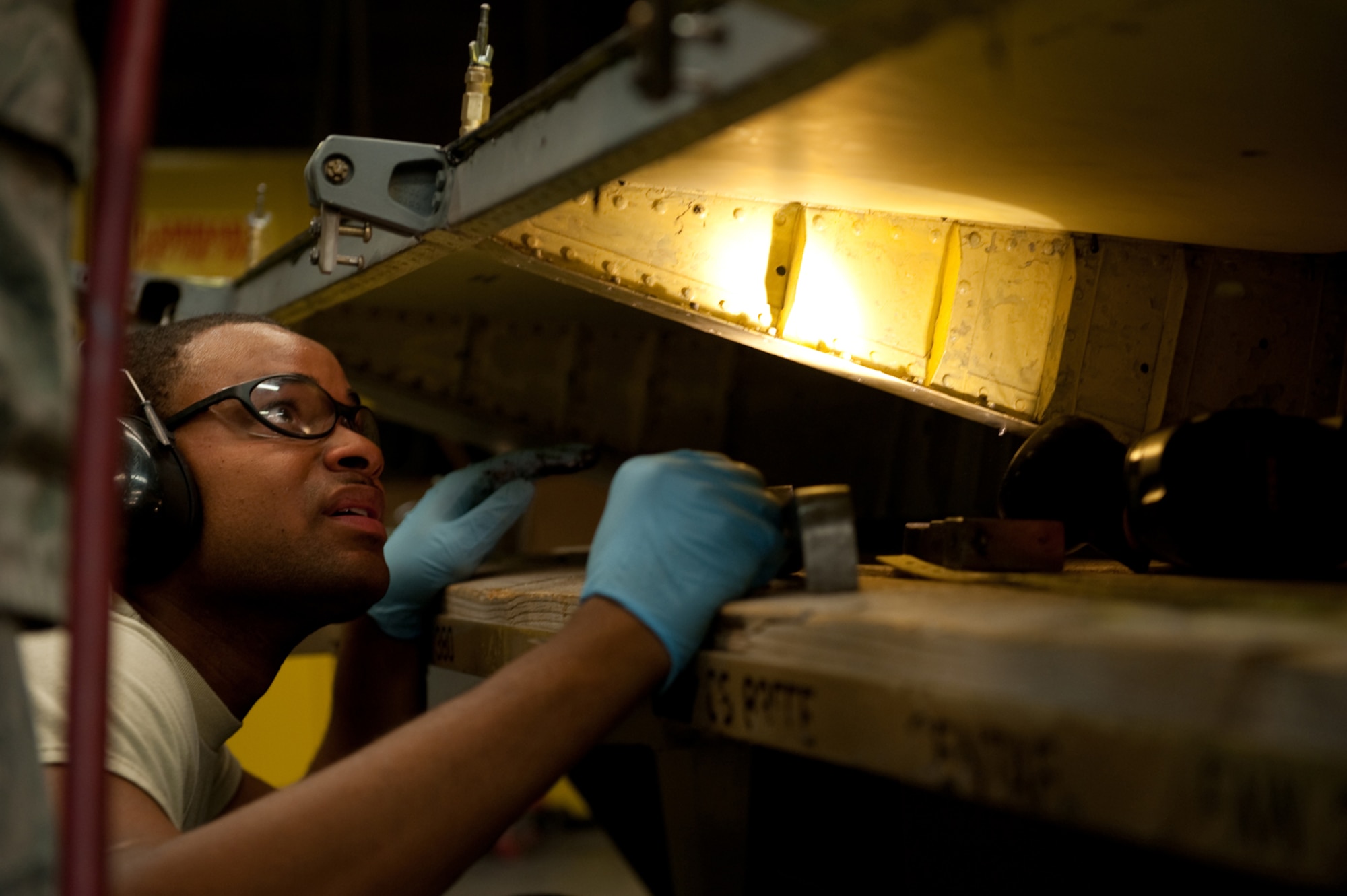 Senior Airman Christopher Jackson, 379th Expeditionary Maintenance Squadron aircraft structural maintainer, rivets a KC-135 Stratotanker aileron, July 27, in Southwest Asia. The 379 EMXS fabrication flight has the ability to construct or repair almost any avionic part, keeping the aircraft flying and maintaining mission readiness. Airman Jackson is a native of Marietta, Ga., and is deployed from Tinker Air Force Base, Okla., in support of Operations Iraqi and Enduring Freedom. (U.S. Air Force Photo/Staff Sgt. Robert Barney)