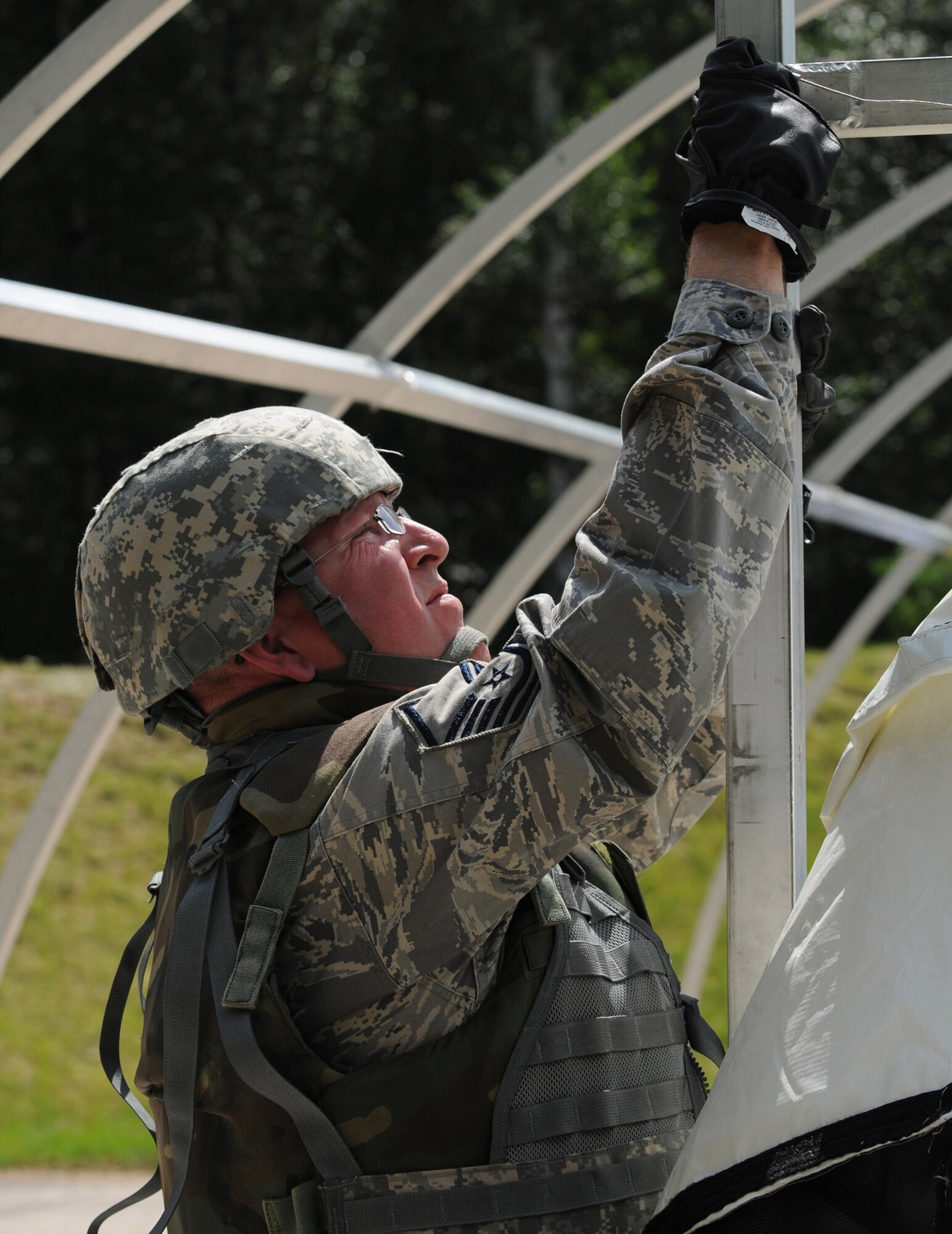 Master Sgt. Leonard Merk, member of the 786th Civil Engineer Squadron Ramstein Air Base, Germany, helps assemble a small shelter system during a weeklong training exercise Silver Flag, August 1, 2009.  The Silver Flag exercise gives participants the basic contingency skills to set up a bed down operation anywhere in the world. (U.S. Air Force photo by:Tech. Sgt. Sean Mateo White)