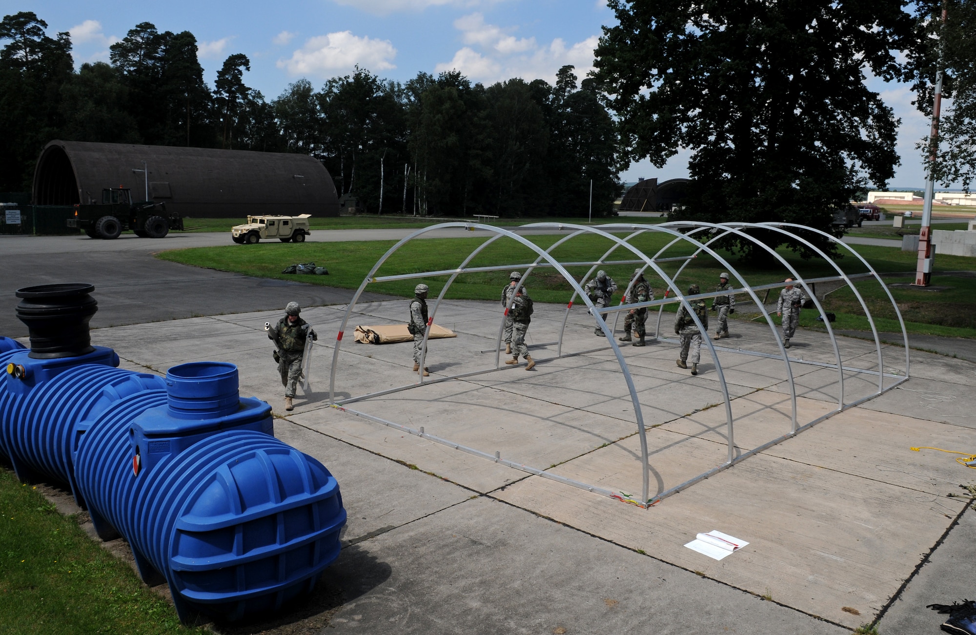 U.S. Air Force Airmen of different bases, wings, and squadrons work together to build a small shelter system tent during the Silver Flag exercise on Ramstein Air Base, Germany, Aug. 1, 2009. There are about nine to ten Silver Flag exercises held throughout the year at the Construction Training Squadron, and the average class size is 100 to 200 people. (U.S. Air Force photo by Airman 1st Class Grovert Fuentes-Contreras)(Released)