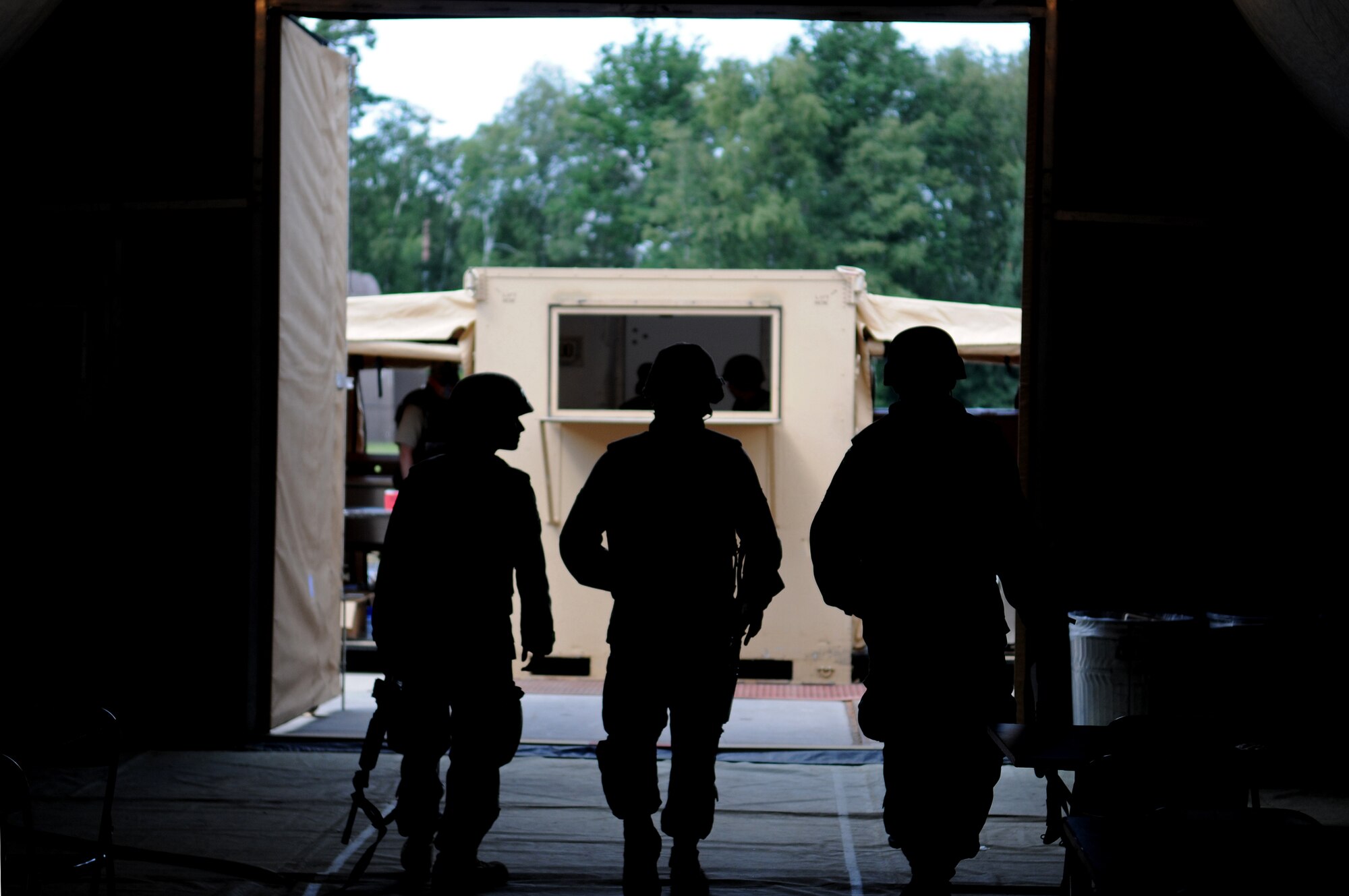 U.S. Air Force Airmen of different bases, wings, and squadrons head out the tent after eating chow to continue the mission during the Silver Flag exercise on Ramstein Air Base, Germany, Aug. 1, 2009. There are about nine to ten Silver Flag exercises held throughout the year at the Construction Training Squadron, and the average class size is 100 to 200 people. (U.S. Air Force photo by Airman 1st Class Grovert Fuentes-Contreras)(Released)