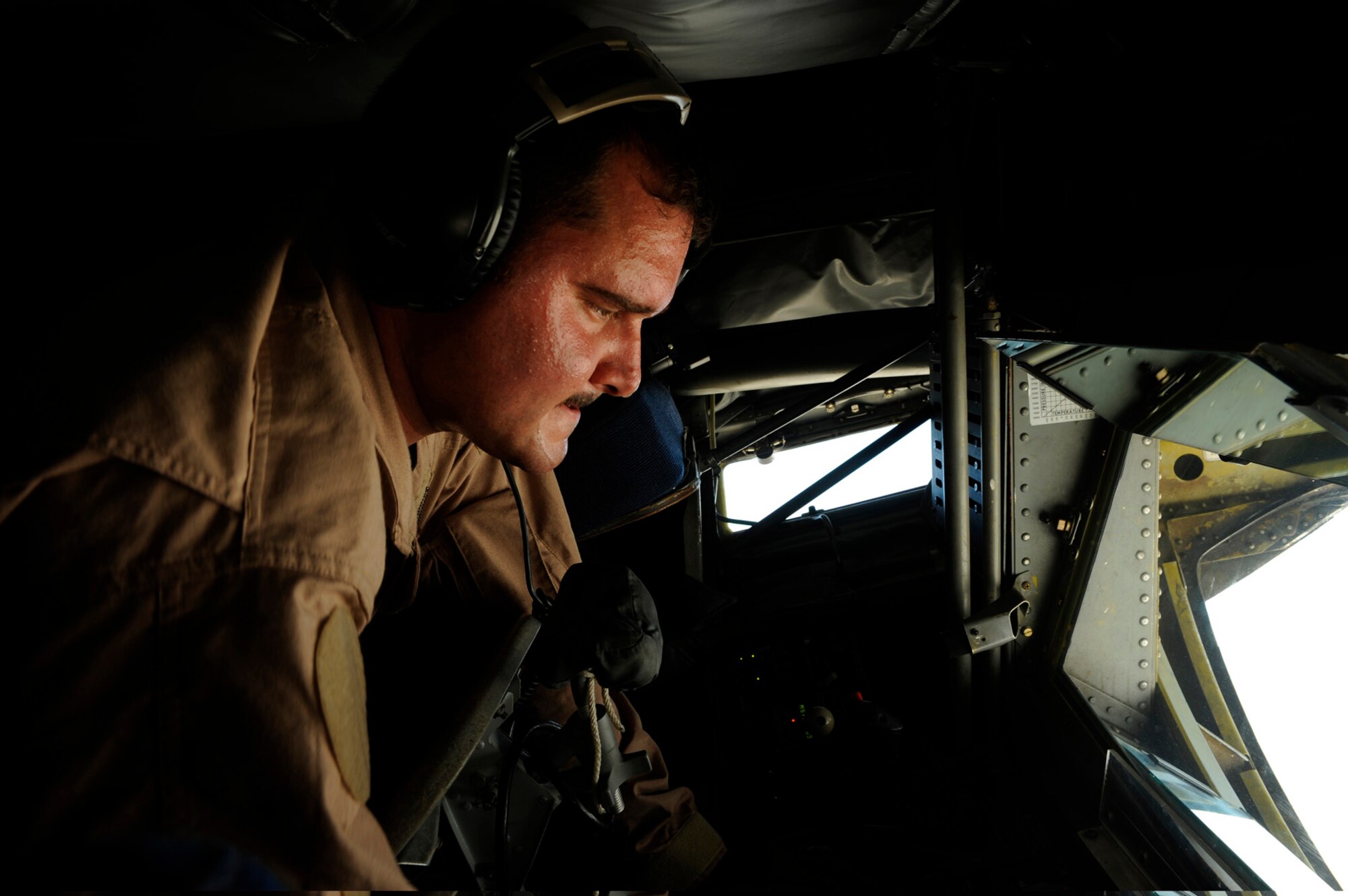 Staff Sgt. Jon Adams, 340th Expeditionary Air Refueling Squadron boom operator, inspects the boom controls on a KC-135 Stratotanker in Southwest Asia, July 28. The KC-135 Stratotanker provides the core aerial refueling capability for the Air Force and has excelled in this role for more than 50 years. (U.S. Air Force photo/Staff Sgt. Michael B. Keller) 
