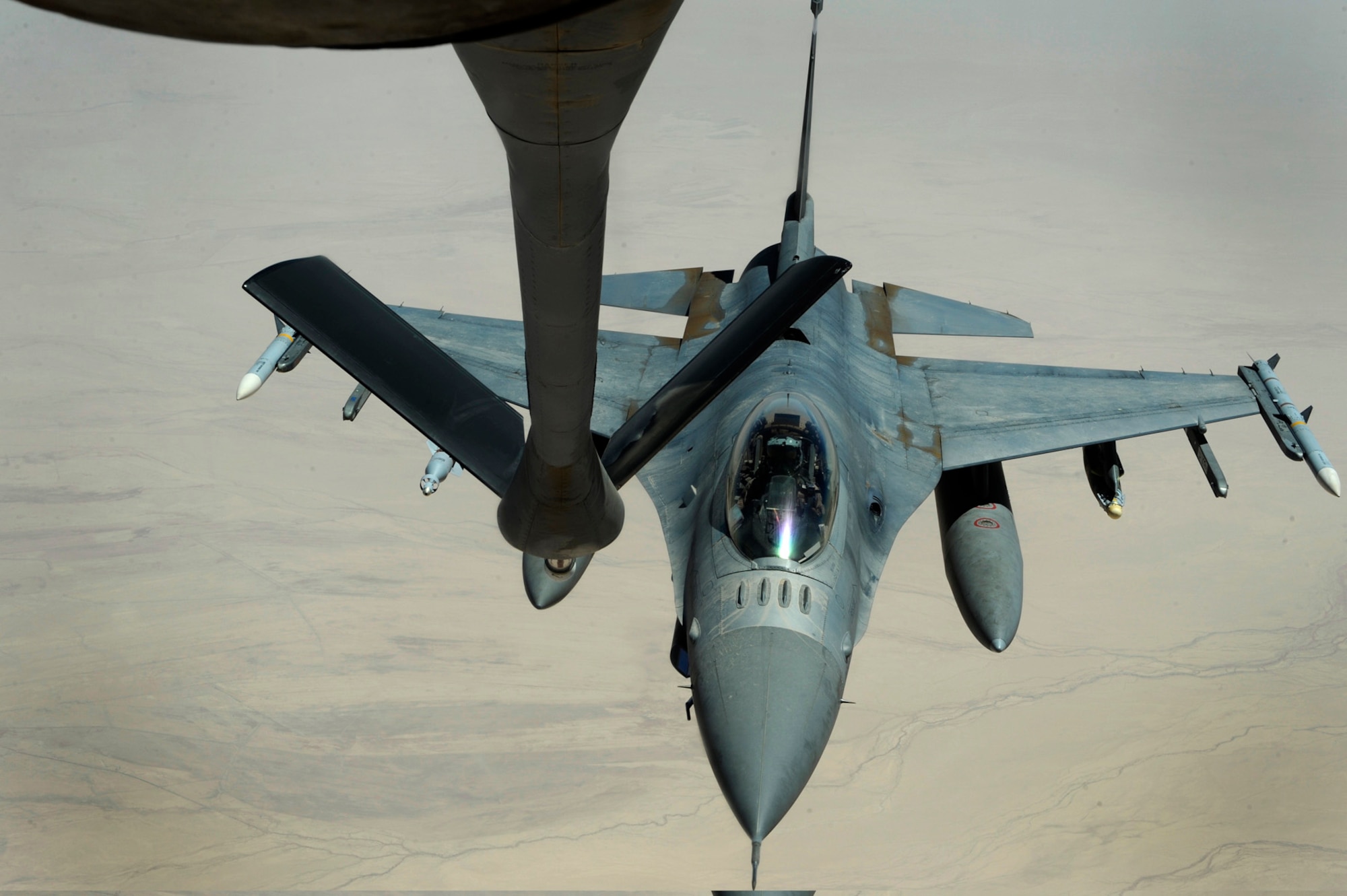 A U.S. Air Force F-16CJ Fighting Falcon approaches a 340th Expeditionary Air Refueling Squadron KC-135 Stratotanker for refueling over Iraq, July 28, in support of Operation Iraqi Freedom. The KC-135 Stratotanker provides the core aerial refueling capability for the Air Force and has excelled in this role for more than 50 years. (U.S. Air Force photo/Staff Sgt. Michael B. Keller) 
