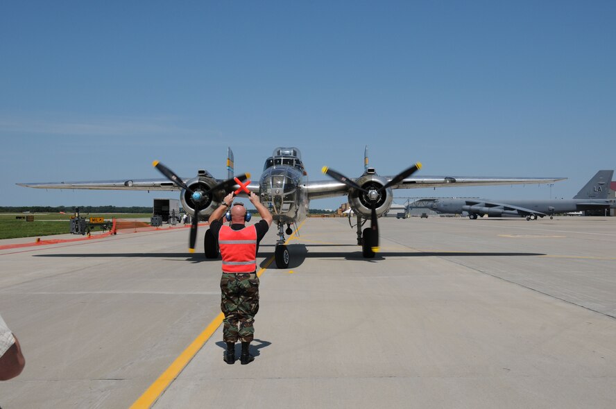 Staff Sgt. Colin Engel parks a B-25 on the ramp at the the Sioux Gateway Airport / Col. Bud Day Field,  in Sioux City, Iowa, as a B-52 sits in the back ground. The B-25 is on display at the Air/Ag Expo hosted by the 185th Air Refueling Wing.  Official Air Force Photo by: MSgt. Bill Wiseman (released)