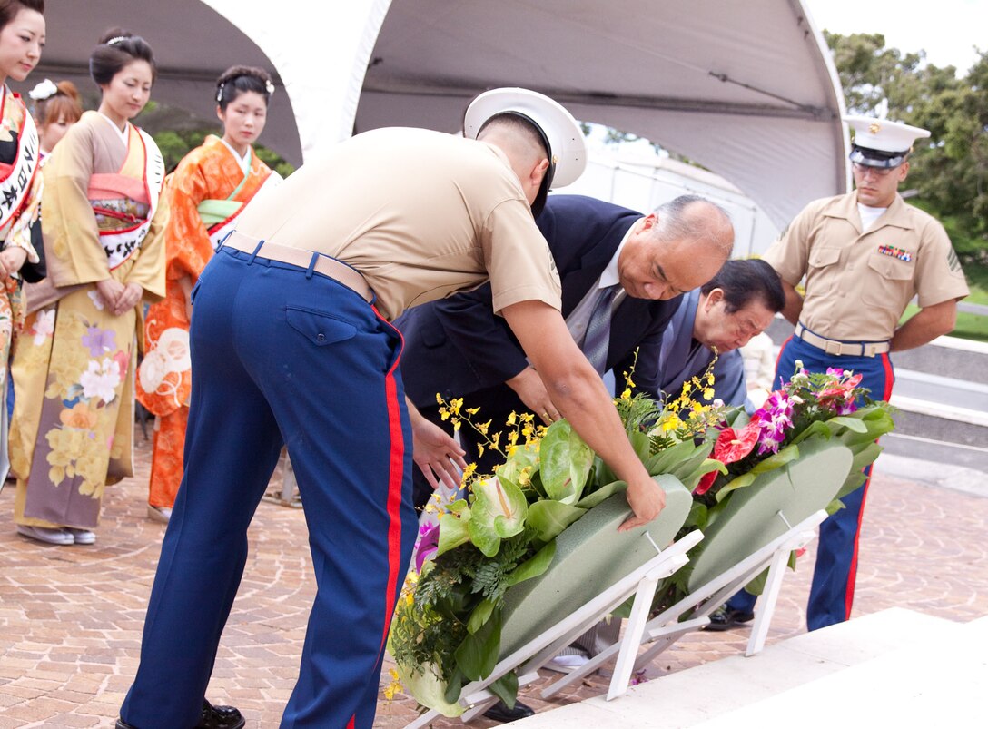 Marines assist Toky-based Hakubi Kiyoto Kimono School officials Takayashi Mizushima and Takami Kondo, as they present wreaths honoring those laid to rest at the National Memorial Cemetery of the Pacific Aug.3. (Official U.S. Marine Corps photo by Cpl. Cristina Noelia Gil) (Released)