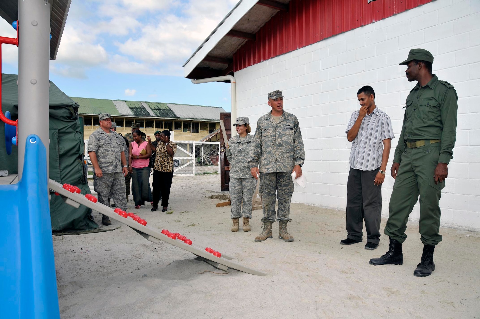 Senior Master Sgt. Scott Lacey, a project manager with the 301st Civil Engineer Squadron, Naval Air Station Joint Reserve Base Fort Worth, Texas, speaks with members of the Guyana Defense Force and Guyana Ministry of Education, during a tour of Timehri Nursery school July 29, 2009 in Georgetown, Guyana. Sergeant Lacey and his Airmen recently completed renovations to the school house, which included two playground sets, new septic system, and repainting the outside and inside of the building. (U.S. Air Force photo by Airman 1st Class Perry Aston) (Released)
