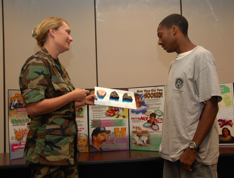 ANDERSEN AIR FORCE BASE, Guam – Maj. Cynthia Pouncey, 36th Medical Operations Squadron health promotion manager and registered dietician at the health and wellness center, discusses the effects of tobacco products to Jordan Walker, a summer hire working at the health and wellness center, here July 29. Tobacco cessation offers the Quit Smart program, a program designed to help military members and dependents kick the habit. (U.S. Air Force photo by Senior Airman Shane Dunaway)