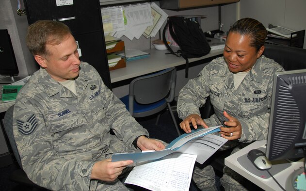 ANDERSEN AIR FORCE BASE, Guam – Senior Airman Shelley Walton, 36th Force Support Squadron force management technician, discusses the enlisted performance report evaluation process with Tech. Sgt. Christopher Hummel, 36th FSS noncommissioned officer in charge of career development, here July 22. Airman Walton, a Koror, Palau, native, was chosen by her unit’s first sergeant as a ‘Top Performer’ for exceeding standards on and off duty. (U.S. Air Force photo by Senior Airman Shane Dunaway)