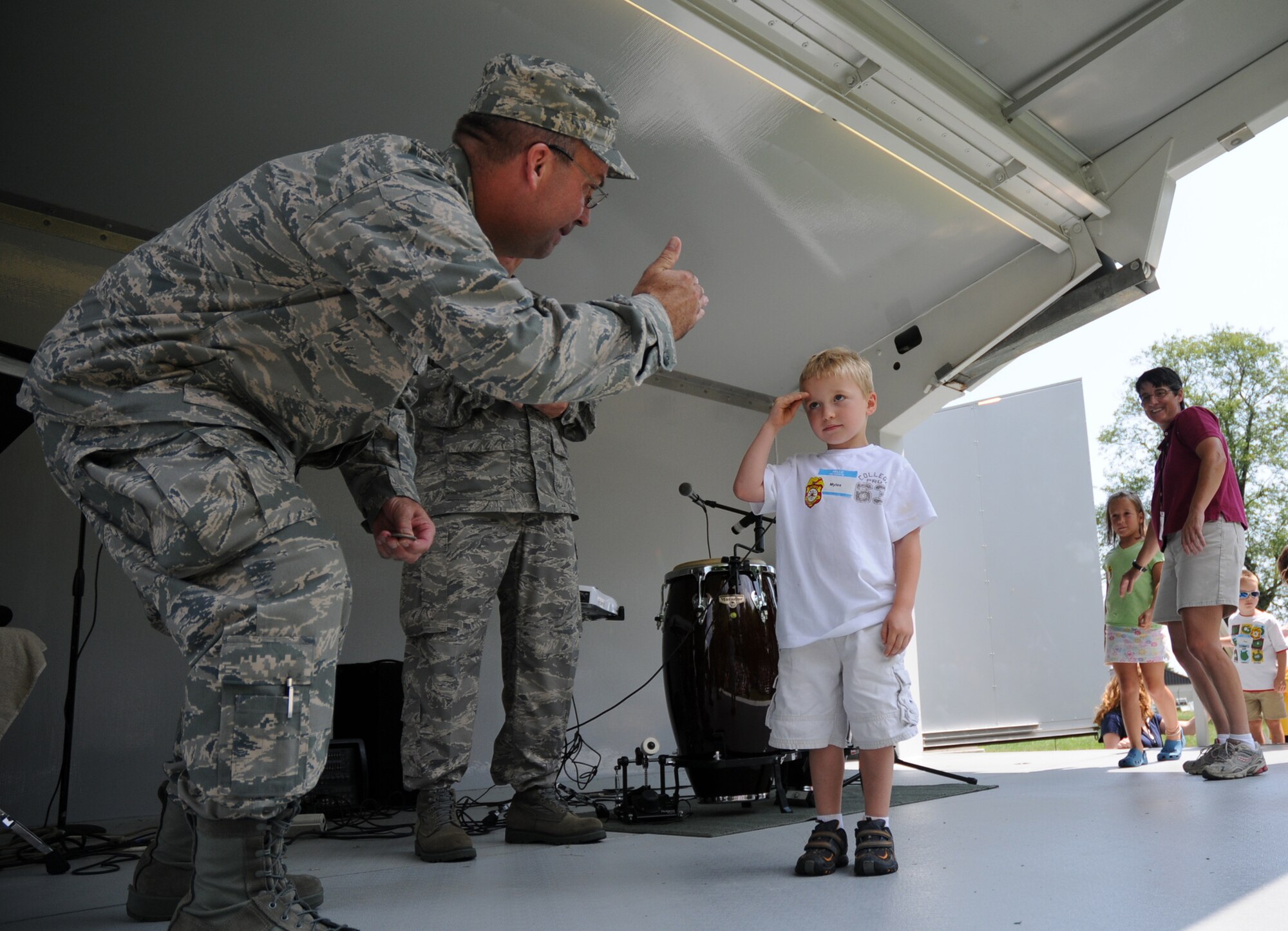 Myles Murphy, 6, salutes 512th Airlift Wing Vice Commander Col. Michael T. Fitzhenry during the wing commander's call Aug. 1 at the Eagle's Nest picnic area here. Myles, son of Lt. Col. Myles Murphy, 512th Mission Support Group deputy commander, was one of almost 40 children who participated in the Galaxy Adventure. This event was hosted by the 512th AW Airman and Familiy Readiness office.  Children received a base tour and participated in the commanders call where they were Colonel Fitzhenry gave them a coin in front of the wing.  Colonel Fitzhenry is commanding the Liberty Wing for Col. Randal L. Bright, 512th AW commander, who is deployed to Southwest Asia.  After the commanders call, the wing then held is biannual picnic. (U.S. Air Force photo/Capt. Marnee A.C. Losurdo)