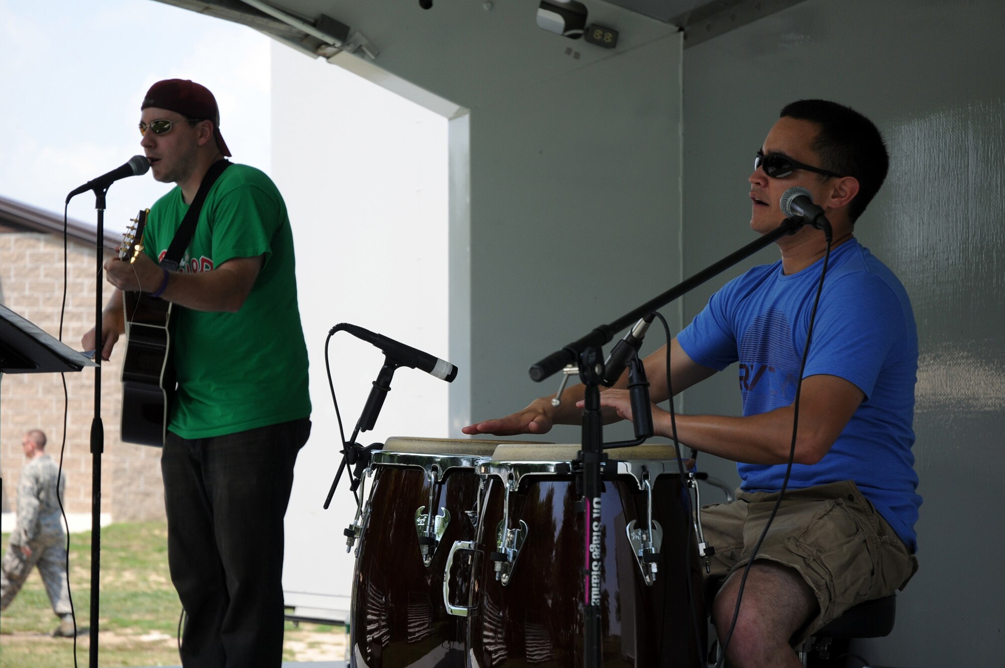 Staff Sgt. Steve Lewis, right, and fellow Lyric Drive band member Ted Stewart perform for an audience of 1,100 reservists and their families at the 512th Airlift Wing picnic Aug. 1 at the Eagle Nest picnic area here. The cover band performs monthly throughout Delaware and Pensylvania. Sergeant Lewis is a member of the 512th Airlift Wing Public Affairs office. (U.S. Air Force photo/Capt. Marnee A.C. Losurdo)
