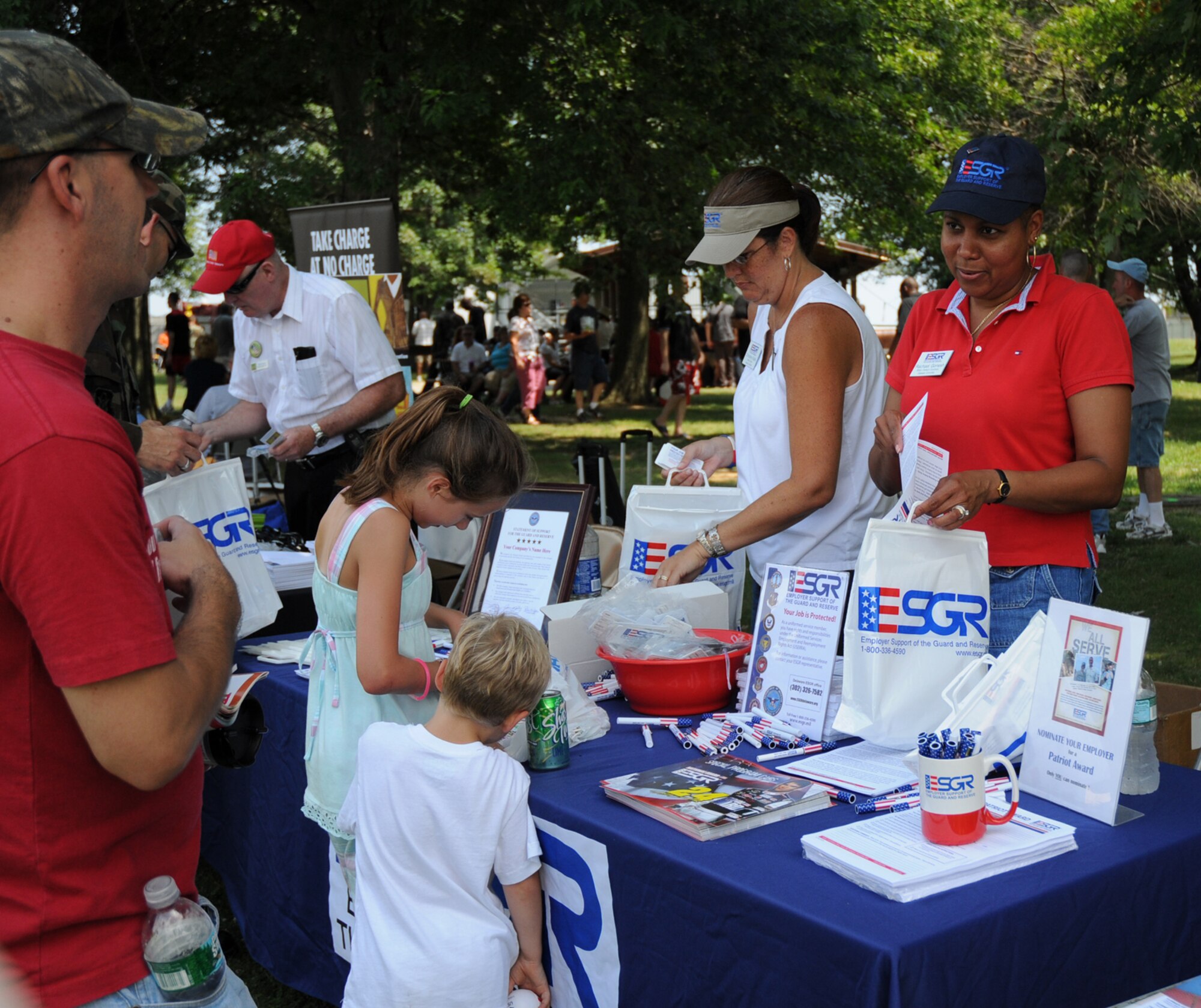 Senior Master Sgt. Rachael Gonesh, right, and Christine Kubik, executive director for Employer Support of the Guard and Reserve Committee for Delaware, hand out ESGR information at the 512th Airlift Wing biannual picnic Aug. 1. ESGR is a Department of Defense organization that seeks to promote a culture in which all American employers support and value the military service of their employees. More than 1,100 wing members and their families attended the event at the Eagle's Nest picnic area. (U.S. Air Force photo/Capt. Marnee A.C. Losurdo)
