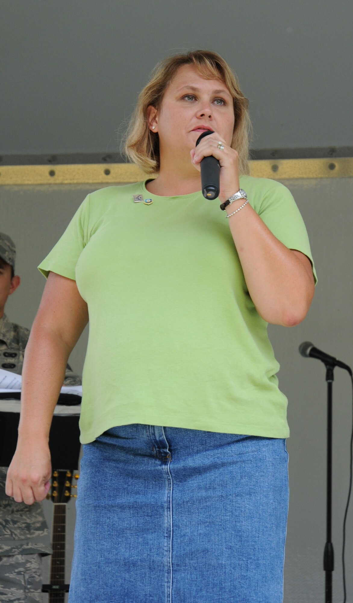 Amy Bright, wife of 512th Airlift Wing Commander Col. Randal L. Bright, addressed more than 1,200 reservists and their families at the wing commanders call Aug. 1 at the Eagle's Nest picnic area.  She gave the audience an update on her husband who is deployed to Southwest Asia and reminded reservists and their spouses about available family support services.  (U.S. Air Force photo/Capt. Marnee A.C. Losurdo)