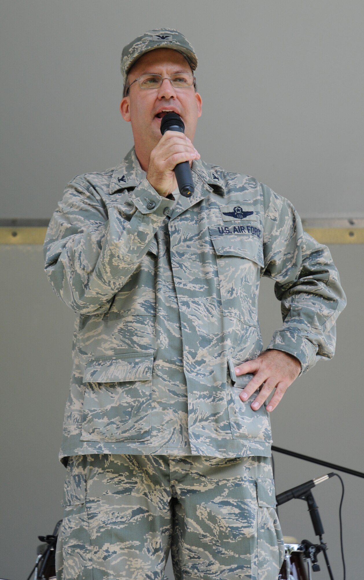 Col. Michael T. Fitzhenry, 512th Airlift Wing vice commander, addresses the wing during his first commanders call Aug. 1. The colonel is commanding the wing while 512th AW Commander Col. Randal L. Bright is deployed to Southwest Asia. After the commanders call the wing hosted its biannual picnic at the Eagle Nest picnic area.  More than 1,000 wing members and their families attended the event. (U.S. Air Force photo/Capt. Marnee A.C. Losurdo)