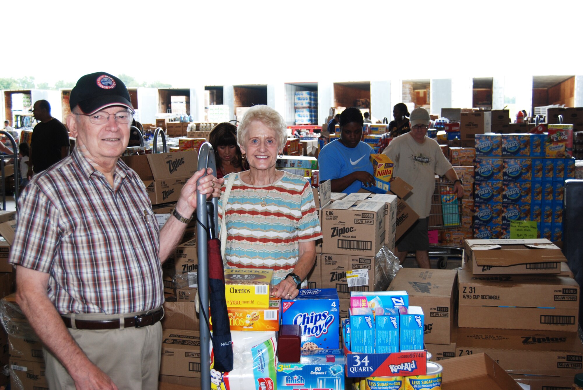 Retired Army Col. George McCoy and his wife Gerda McCoy search for good deals at the Case Lot Sale July 31 inside Hangar 5. The sale is held every quarter and offers discounted groceries to retirees and current Airmen. (U.S. Air Force Photo/Senior Airman Quadoah Ford)
