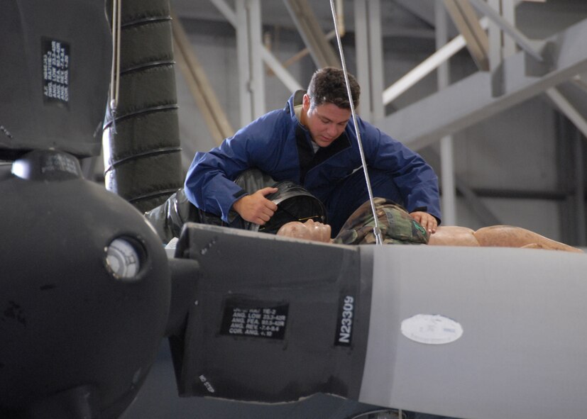 Tech Sgt. David Dean, 919th Maintenance Squadron, aids the simulated victim during a fuel cell extraction exercise Aug. 1 and Duke Field.  Maintainers and firefighters participated in the simulated accident and response.  Evaluators watched to ensure the proper steps are known and taken in the case of an emergency.  (U.S. Air Force photo/Staff Sgt. Samuel King Jr.)