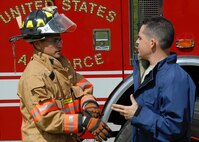 Master Sgt. Nicholas Barlotta, 919th Maintenance Squadron, briefs Senior Airman Albert Hetrick, 96th Civil Engineer Squadron, about the simulated fuel cell incident Aug. 1 before the firefighters enter the hangar.  Maintainers and firefighters participated in the simulated accident and response exercise.  Evaluators watched to ensure the proper steps are known and taken in the case of an emergency.  (U.S. Air Force photo/Staff Sgt. Samuel King Jr.)