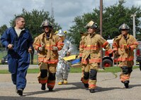 Master Sgt. Nicholas Barlotta, 919th Maintenance Squadron, leads the firefighters into the hangar to begin evacuating the victim of a simulated confined space exercise Aug. 1 at Duke Field.  Maintainers and firefighters participated in the simulated accident and response exercise.  Evaluators watched to ensure the proper steps are known and taken in the case of an emergency.  (U.S. Air Force photo/Staff Sgt. Samuel King Jr.)
