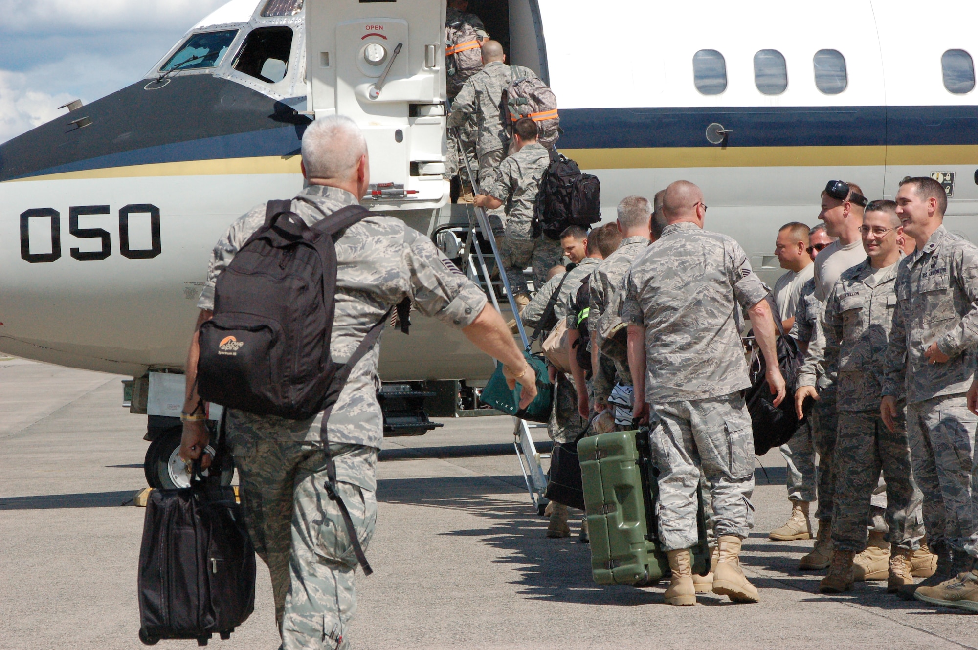 The 103rd Aircraft Maintenance Squadron and 118th Airlift Squadron, both out of the 103rd Airlift Wing, Conn. Air National Guard, boarded a C-9 on the ramp at Bradley ANG Base, East Granby, Conn. July 19, 2009, deploying to Southeast Asia in support of overseas contingency operations. The deployment will be the first overseas maintenance deployment for the 103rd Airlift Wing since acquiring the C-21 bridge mission.  (U.S. Air Force Photo by Tech. Sgt. Josh Mead)