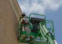 Ray Callin, Washington Painting, paints the top of the parachute shop July 30 at Duke Field.  (U.S. Air Force photo/Staff Sgt. Samuel King Jr.)